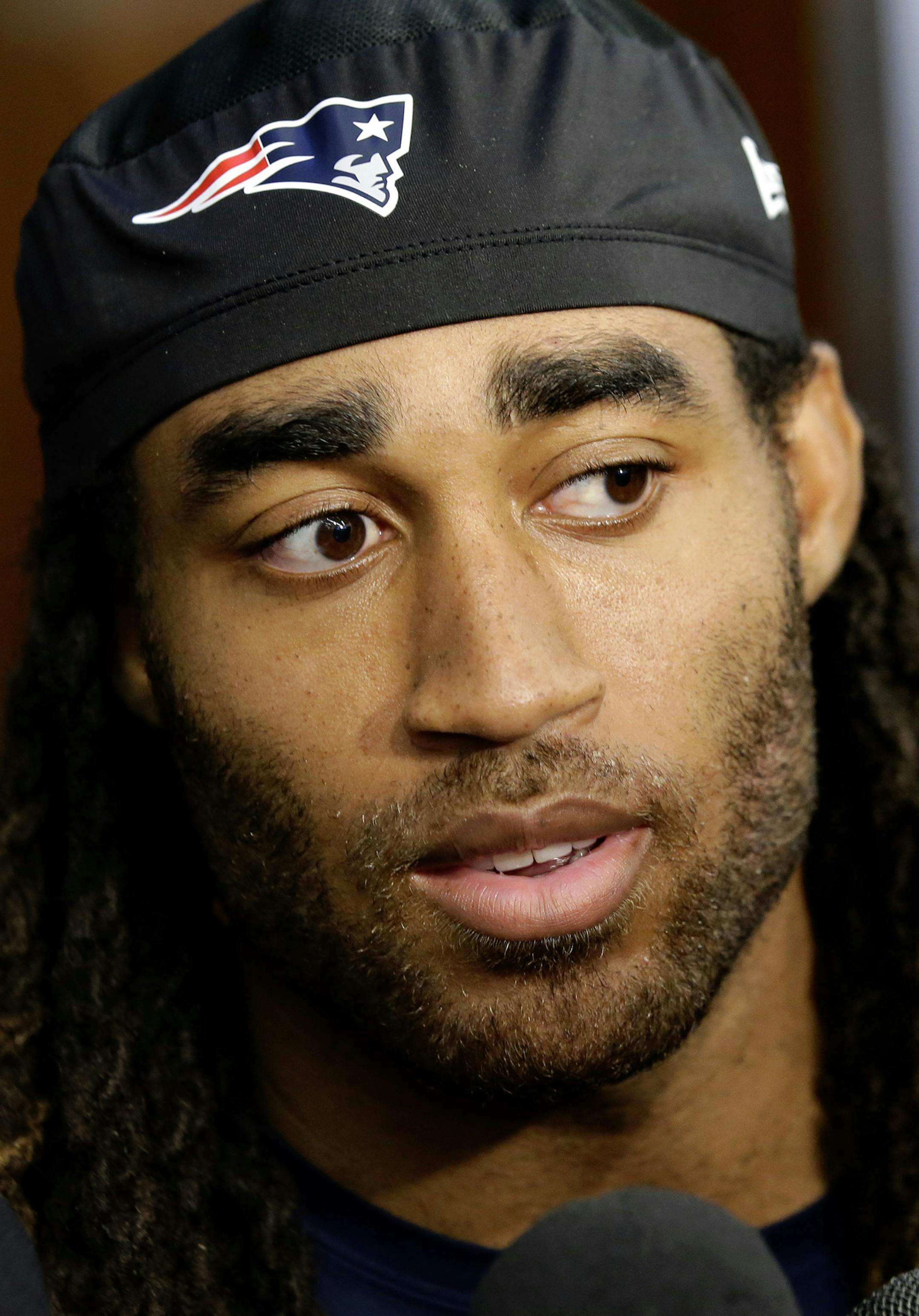 New England Patriots cornerback Stephon Gilmore faces reporters in the team's locker room following an NFL football practice, Wednesday, Sept. 19, 2018, in Foxborough, Mass. (AP Photo/Steven Senne) ORG XMIT: MASR1
