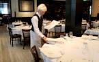 Manny's Steakhouse server Jody Woods place menus on the table for lunch Tuesday, March 14, 2017, in downtown Minneapolis, MN.] DAVID JOLES &#xef; davi
