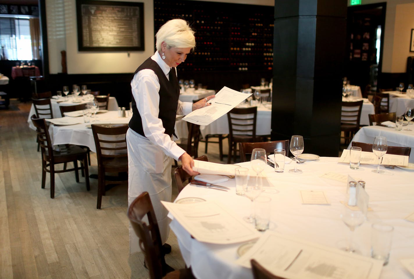 Manny's Steakhouse server Jody Woods place menus on the table for lunch Tuesday, March 14, 2017, in downtown Minneapolis, MN.] DAVID JOLES &#xef; david.joles@startribune.com Q&A with Manny's Steakhouse founder (and Parasole Restaurant Holdings co-owner) Phil Roberts, on the hugely popular restaurant's history and legacy.**Jody Woods ,cq