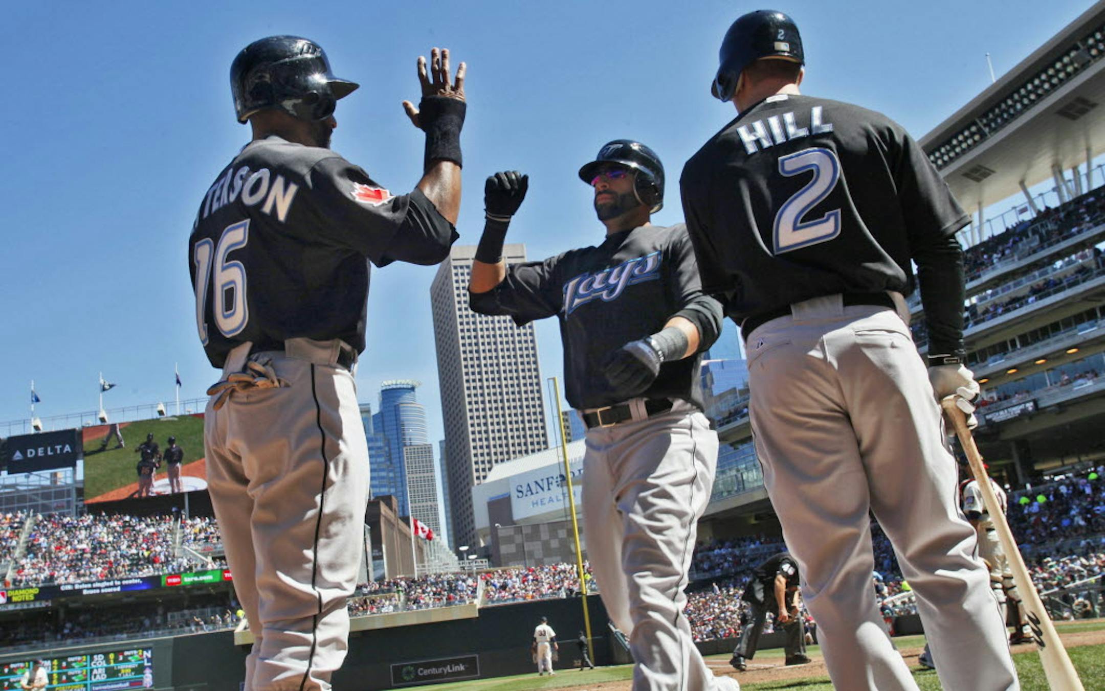 Tornonto's Jose Bautista, center was congratulated by teammates after he hit his third home run of the game in the sixth inning.