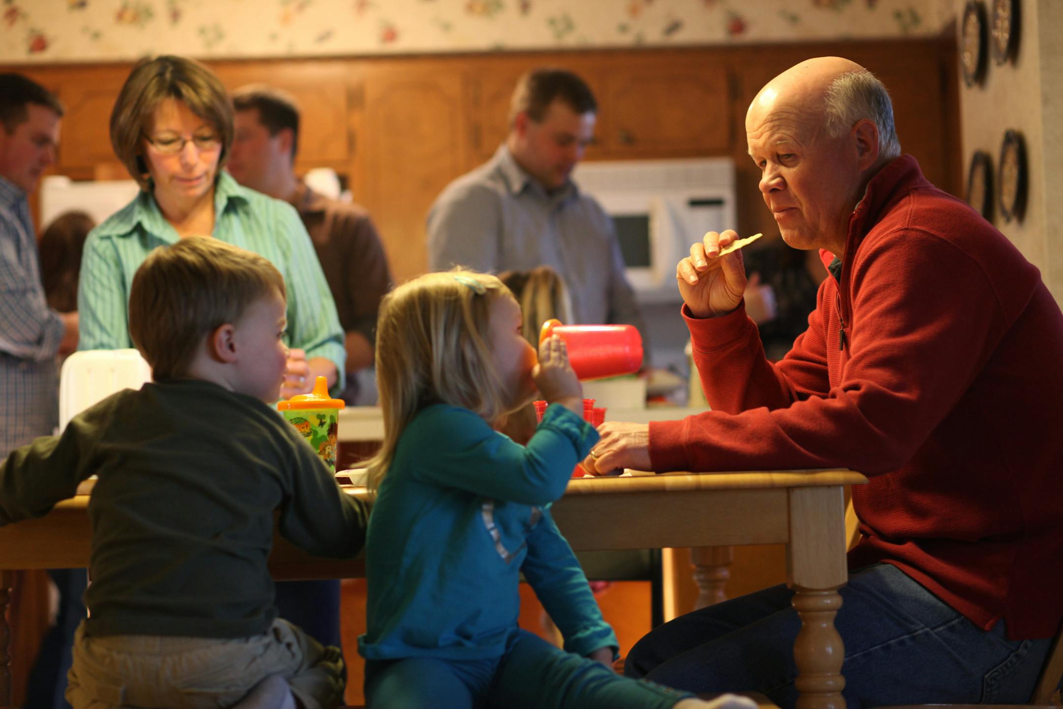 John Frei, chatting with two of his grandchildren at a family dinner this month, says: "I'm going to live like I can beat this thing."
