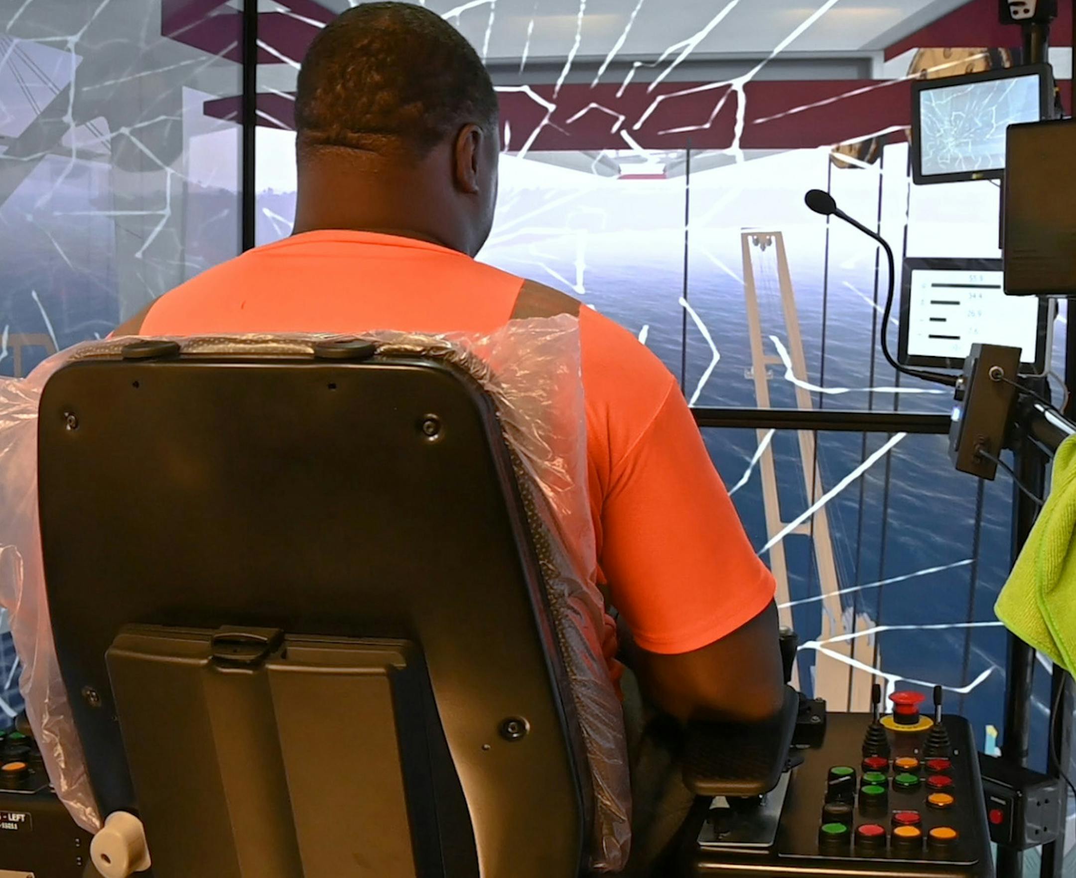 Antwon Lemon, an 18-year Baltimore longshoreman, demonstrates an error while training in a new crane simulator at the Port of Baltimore, prompting a cracked screen. The Steamship Trade Association of Baltimore, which represents port employers including Ports America Chesapeake, the company that runs the state-owned container terminal, bought a $500,000 simulator this year to train crane operators in various conditions without affecting the day-to-day loading and unloading of cargo. (Ulysses Muno