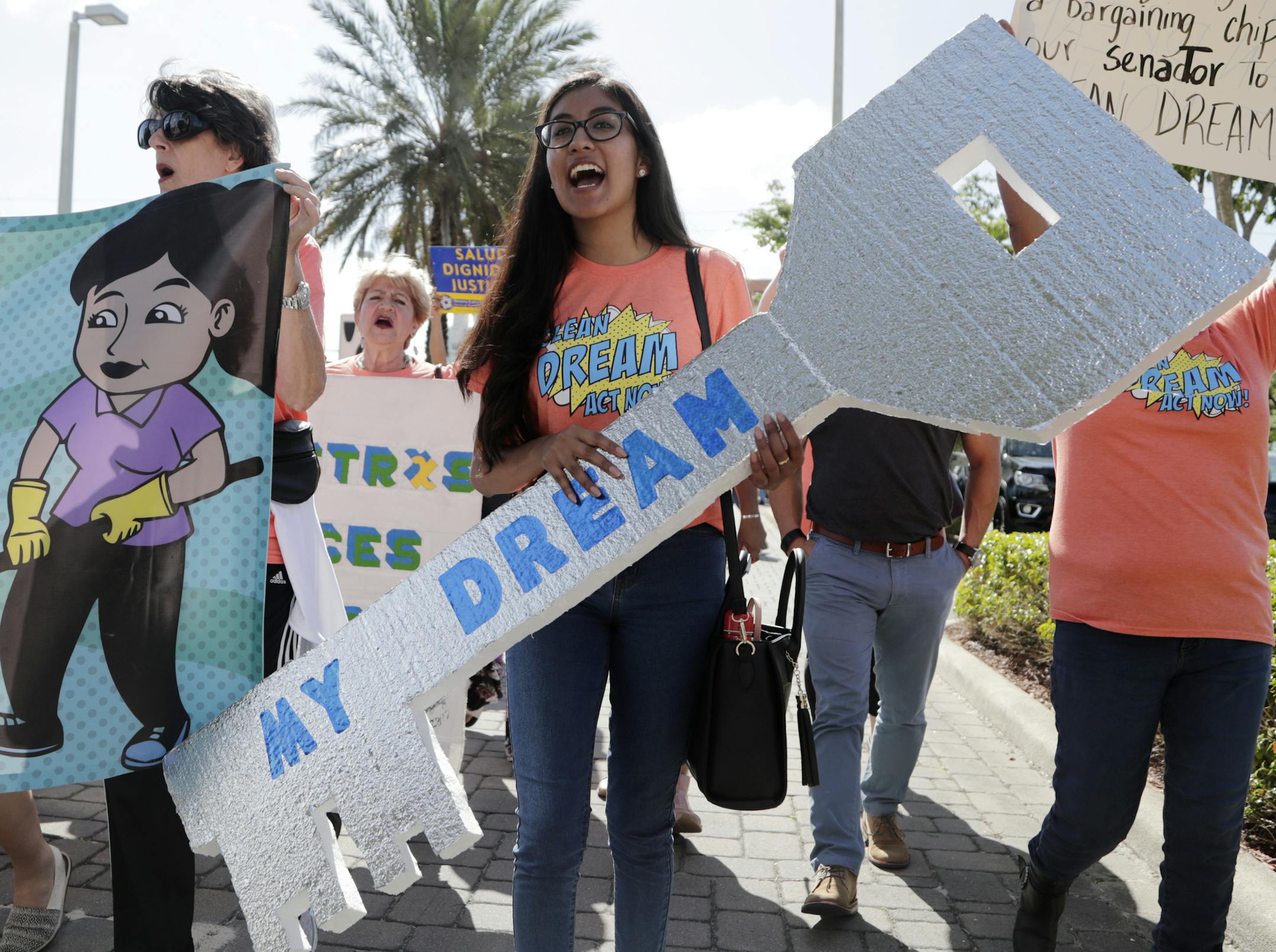 Maria Angelica Ramirez carried a large key reading "My Dream" during a protest outside the office of Sen. Marco Rubio, R-Fla., in support of Congress passing a clean Dream Act, Monday, Jan. 22, in Doral, Fla.