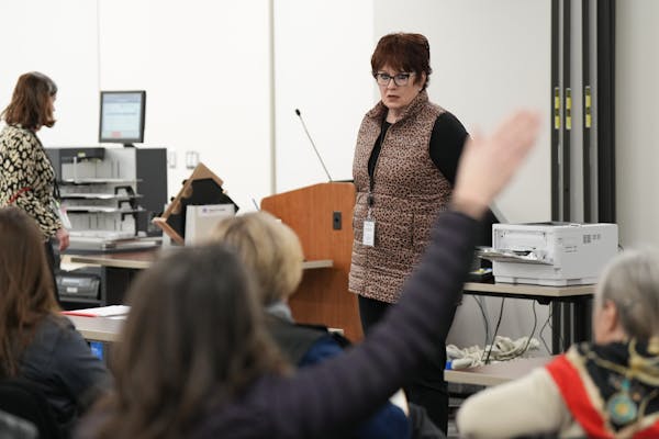 Rice County elections officials, including elections director Denise Anderson, center, held a voting machine accuracy test that was open to the public