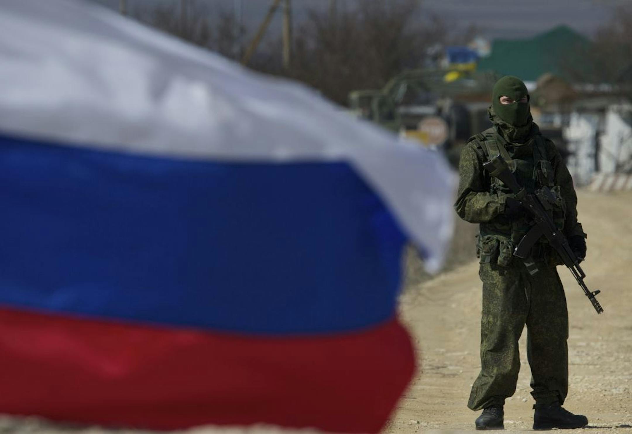 Pro-Russian soldiers block the Ukrainian naval base in the village of Novoozerne, some 91 km west of Crimean capital Simferopol, Ukraine, on Monday, March 3, 2014. Ukraine says Russian forces controlling the strategic region of Crimea are demanding that the crew of two Ukrainian warships in Sevastopol's harbor must surrender.