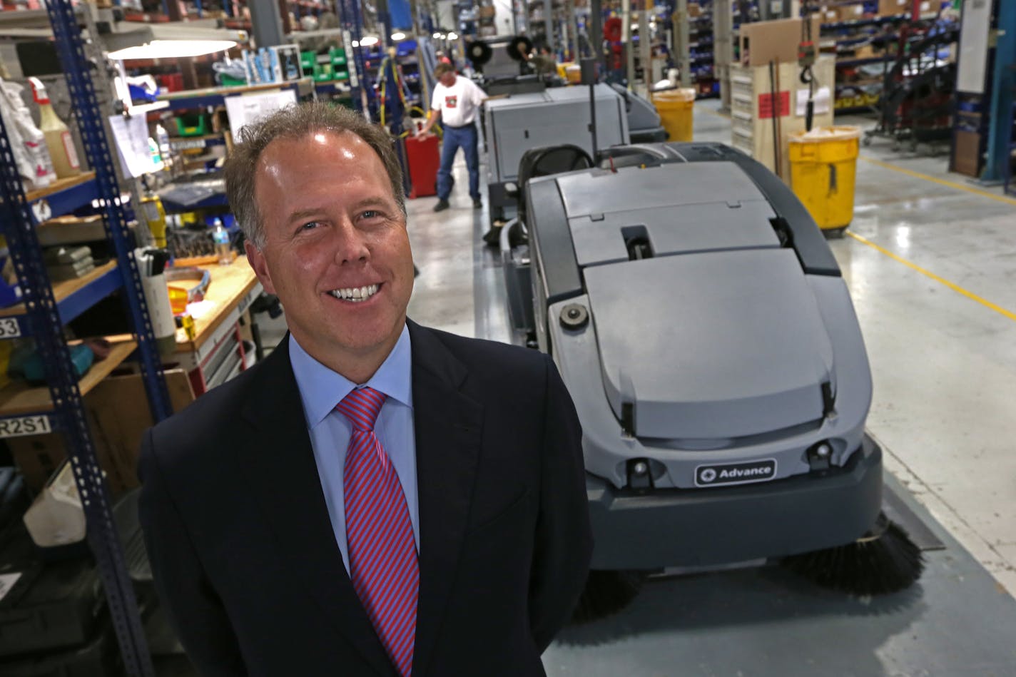 Nilfisk-Advance U.S. President Jeff Barna was photographed on 10/23/13 with an Advance CS7000 hybrid floor cleaner being built at the Plymouth MN factory. Danish company Nilfisk Advance, the low-profile competitor to Tennant in the floor-cleaning business for years, is bigger than Tennant and its U.S. operations, located just a few miles from Tennant's headquarters, has grown sales faster than the market or Tennant over the last 16 months under new leadership that arrived in 2012.] Bruce Bisping