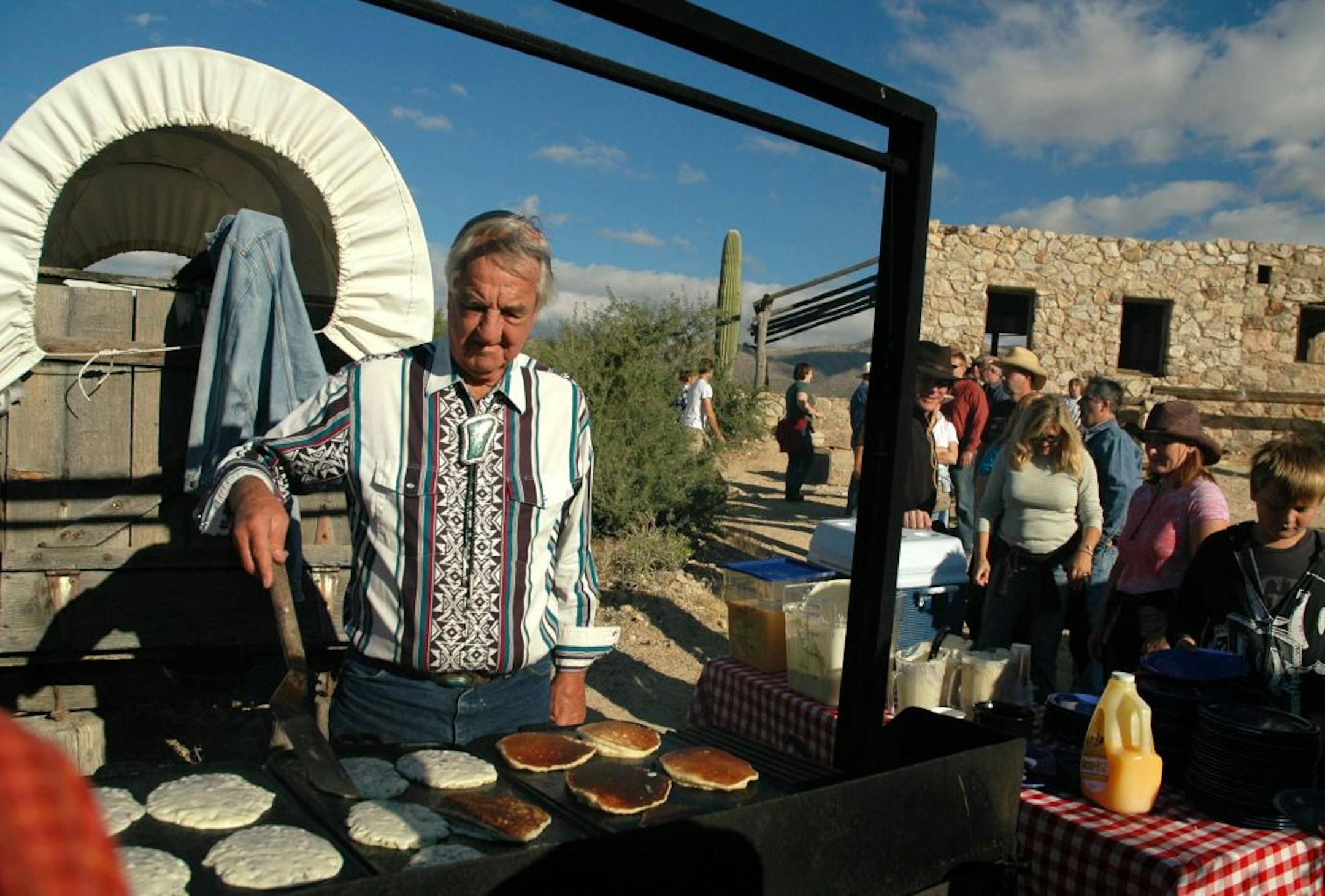 Bob Cote flips pancakes at a special Sunday trailside breakfast before riders continue into the desert.Photo by Jim Buchta