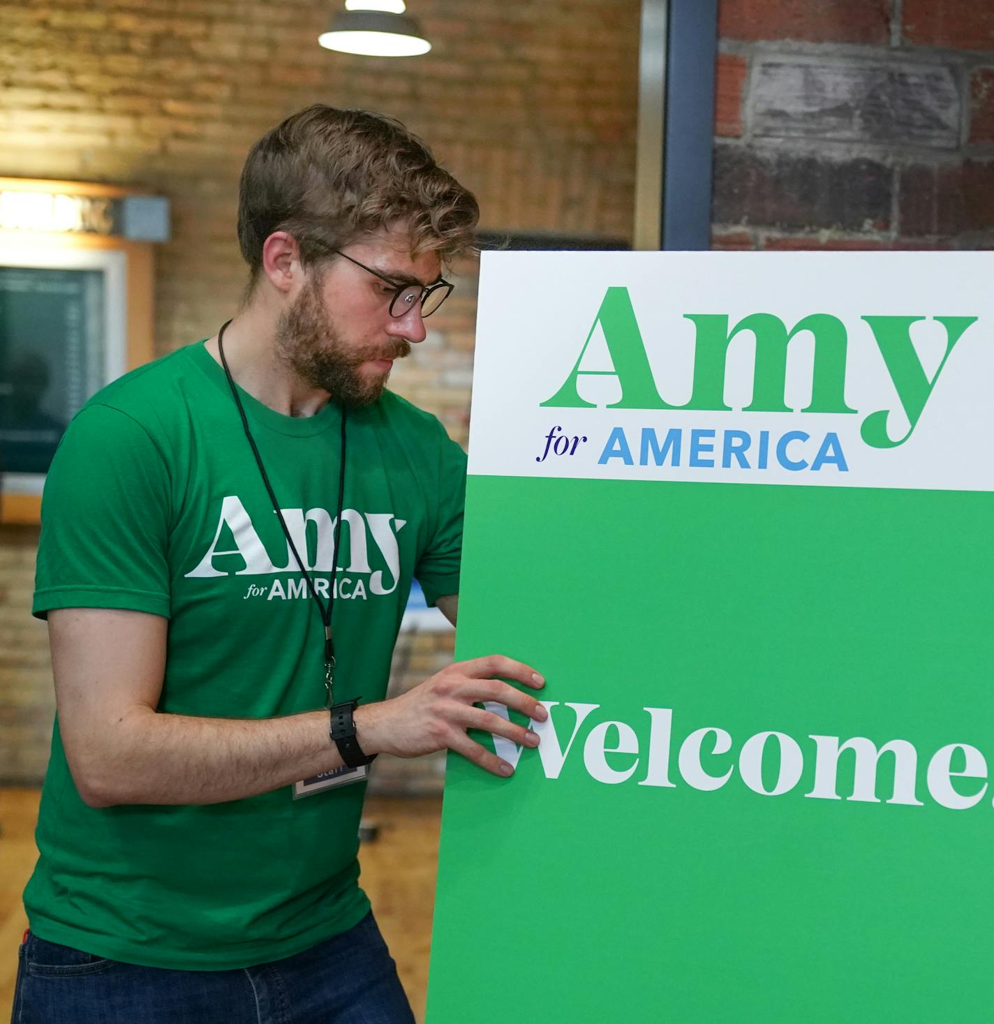 Klobuchar staffer David Roland set out welcome signs for Thursday night's office opening party at Klobuchar's new Minnesota presidential campaign headquarters. It is in the Banks Building, Suite 125 &#x2014; 615 NE 1st Avenue, Minneapolis. ] GLEN STUBBE &#x2022; glen.stubbe@startribune.com Thursday, May 23, 2019 Klobuchar opens presidential campaign HQ in Mpls.