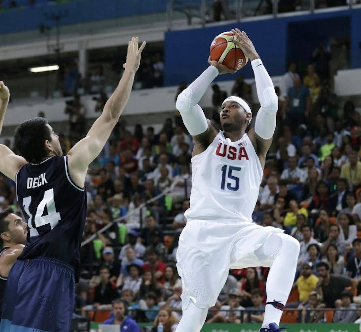 Carmelo Anthony (15) shots over Argentina's Gabriel Deck (14) during a men's quarterfinal round basketball game at the 2016 Summer Olympics in Rio de Janeiro