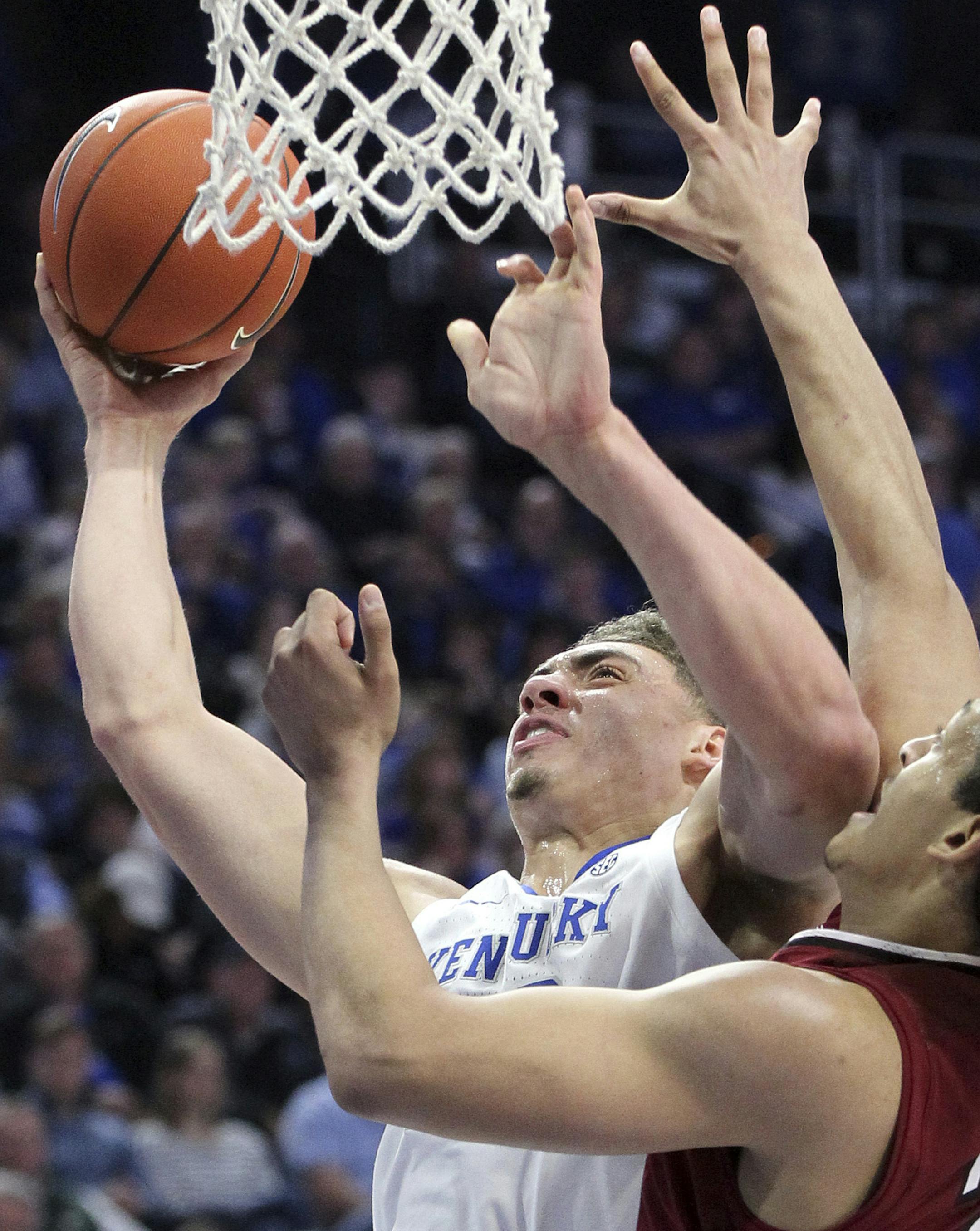Kentucky's Reid Travis, left, shoots while defended by South Carolina's Alanzo Frink during the first half of an NCAA college basketball game in Lexington, Ky., Tuesday, Feb. 5, 2019. (AP Photo/James Crisp)