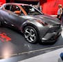 FILE- In this Sept. 12, 2017, file photo, a man films a Toyota C-HR concept on the first media day of the International Frankfurt Motor Show IAA in Fr