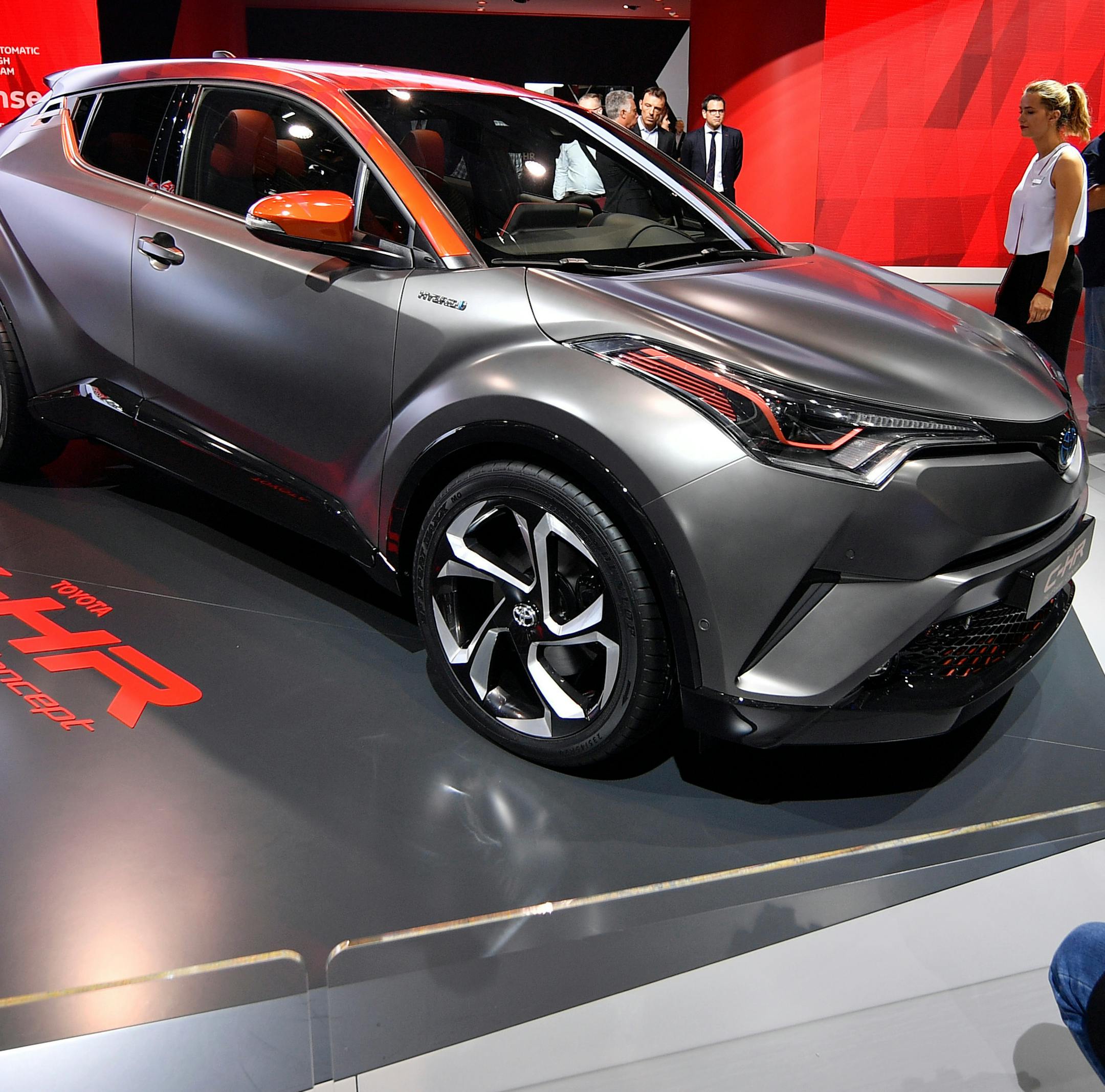 FILE- In this Sept. 12, 2017, file photo, a man films a Toyota C-HR concept on the first media day of the International Frankfurt Motor Show IAA in Frankfurt, Germany. The highly stylized 2018 Toyota C-HR is an all-new subcompact SUV sporting aggressive body lines and plenty of standard features.(AP Photo/Martin Meissner, File)