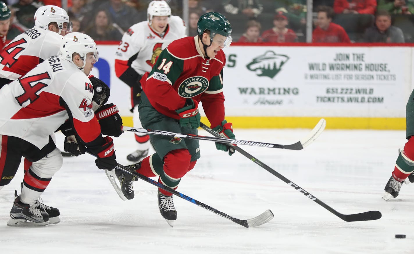 Joel Eriksson Ek(14) tries to get away with the puck.]At the Xcel Energy Center in a game between the Wild and Ottawa.Richard Tsong-Taatarii/richard.tsong-taatarii@startribune.com