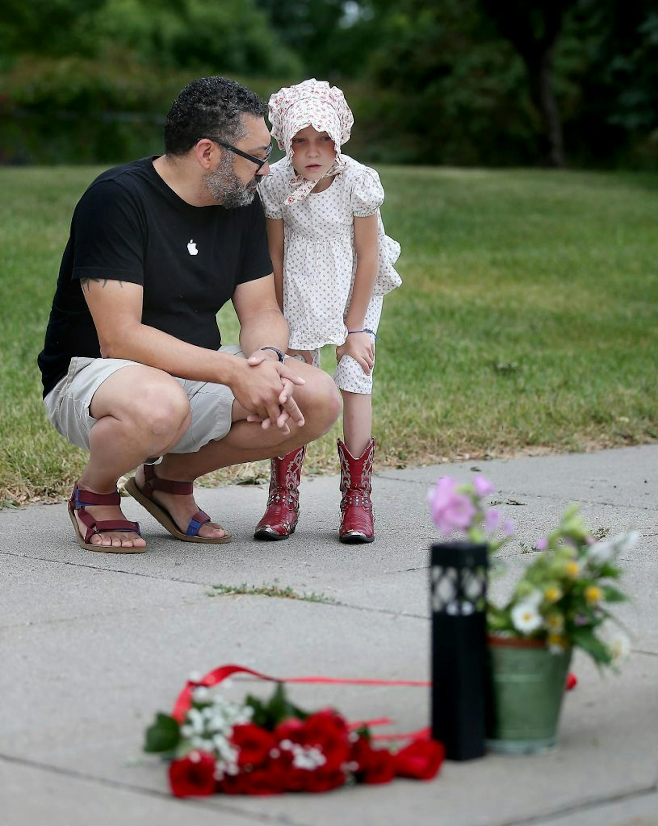 Patrick Rhone became emotional as he showed his daughter, Beatrix Rhone, 8, the scene where a man was shot by a police officer, Thursday, July 7, 2016 in Falcon Heights, MN.