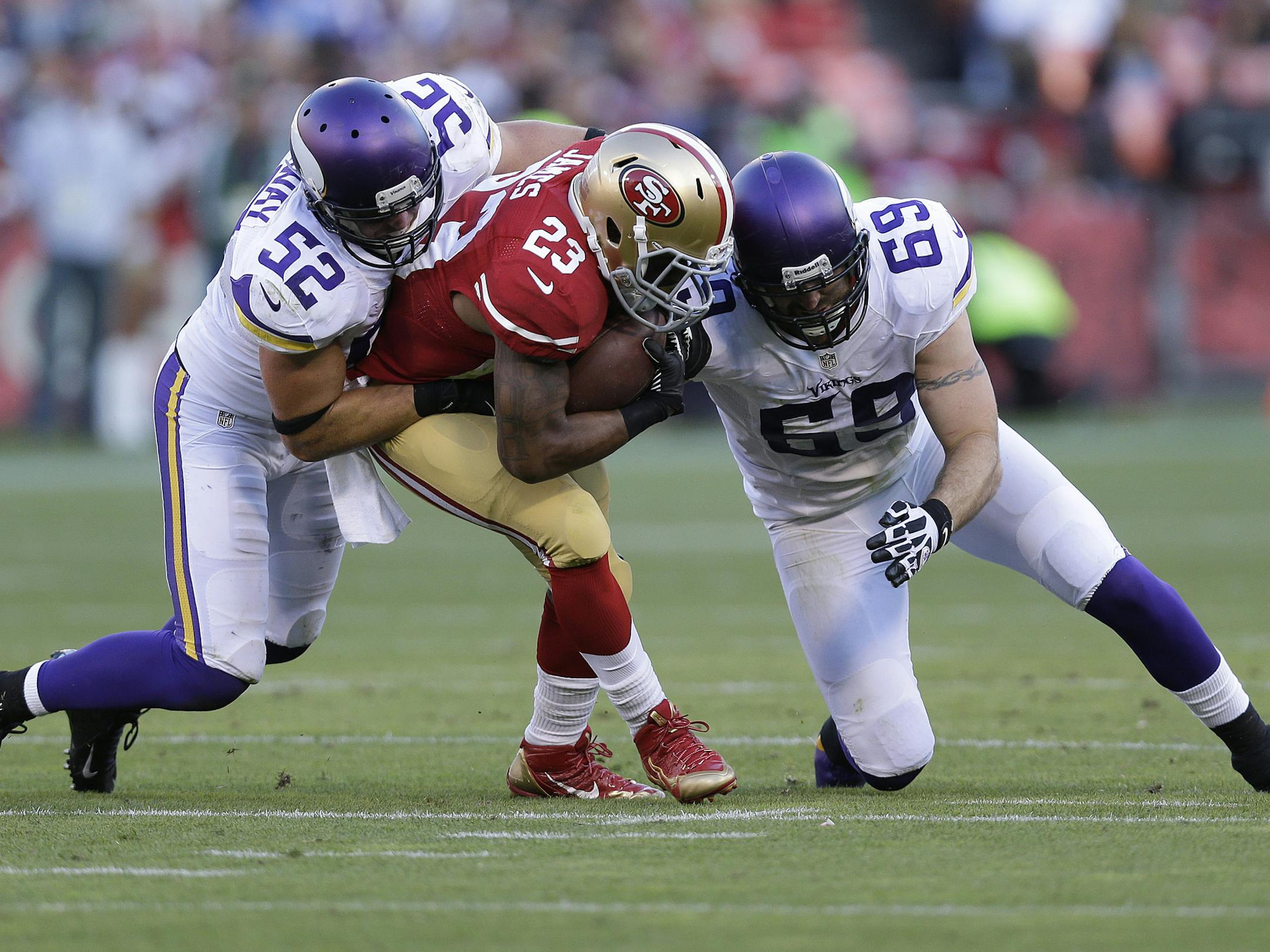 San Francisco 49ers running back LaMichael James (23) is tackled by Minnesota Vikings linebacker Chad Greenway (52) and defensive end Jared Allen (69) during the second quarter of an NFL preseason football game in San Francisco, Sunday, Aug. 25, 2013. (AP Photo/Marcio Jose Sanchez) ORG XMIT: NYOTK