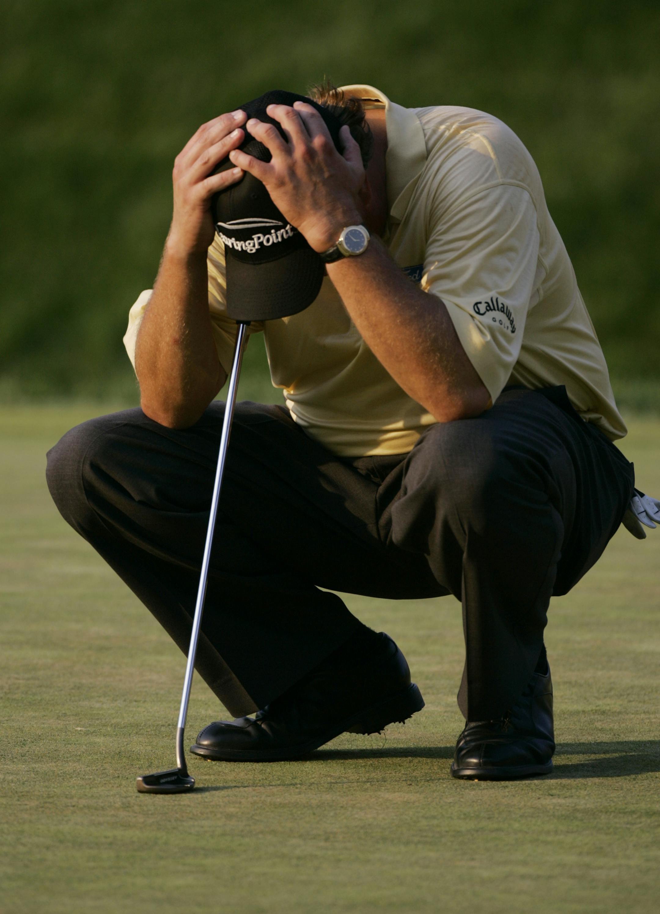 FILE - In this June 18, 2006, file photo Phil Mickelson reacts after double-bogeying the 18th hole in the final round of the U.S. Open golf tournament at Winged Foot Golf Club in Mamaroneck, N.Y. With a one-shot lead playing the 18th hole, Mickelson hit a wild slice toward the corporate tent and tried to hit 3-iron around a tree toward the green. He made double bogey. (AP Photo/Charles Krupa, File) ORG XMIT: NYDDD222