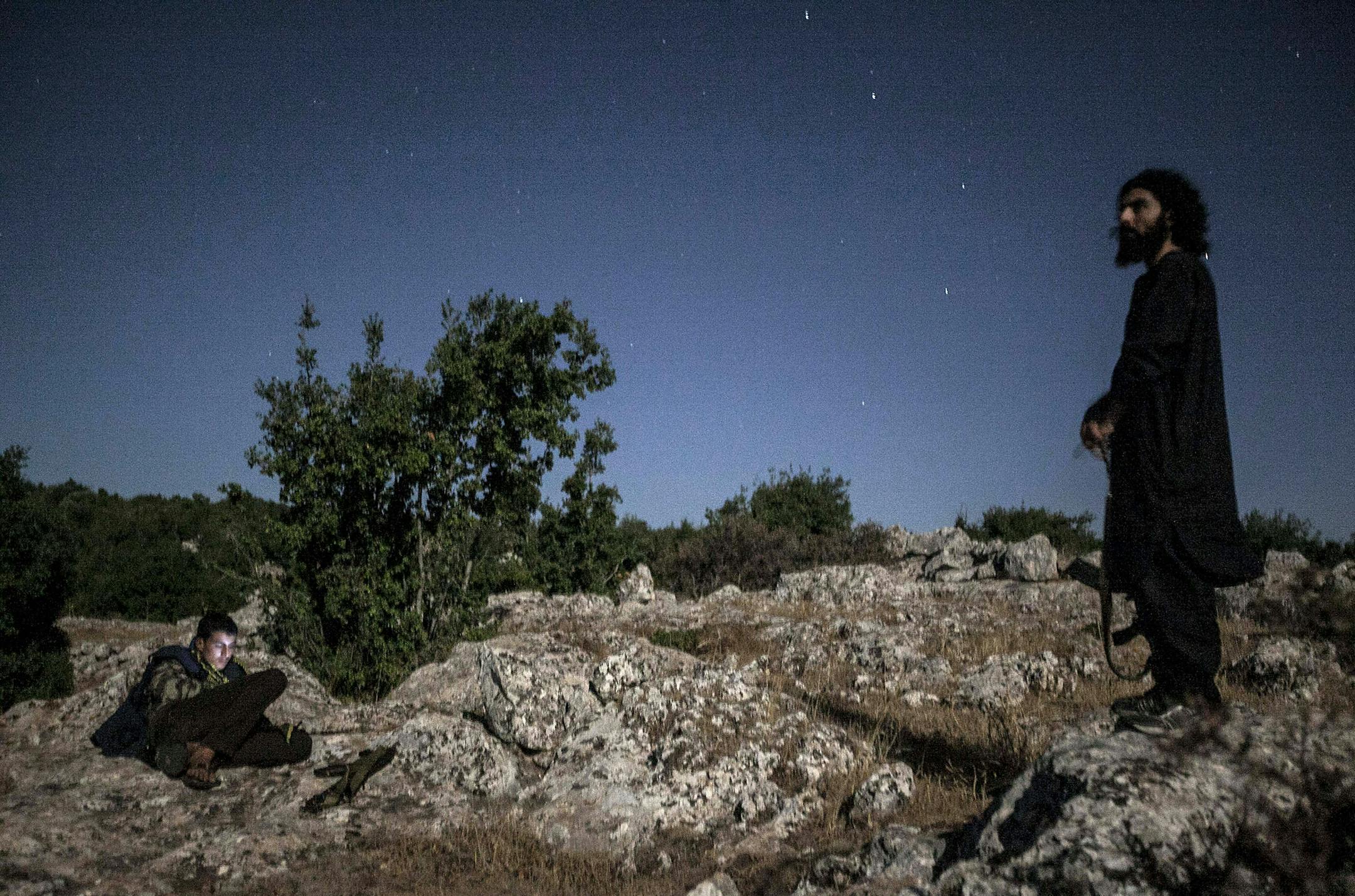 In this Wednesday, Sept. 18, 2013 photo, Syrian opposition fighters are seen at the top of a mountain in the vicinity of a rebel camp in Idlib province, Syria. For Syria's divided and beleaguered rebels, the creeping realization that there will not be a decisive Western military intervention on their behalf is a huge psychological blow. It now appears that the regime of Bashar Assad has gained time, largely because the world community is too concerned that if he is toppled the result may be an I