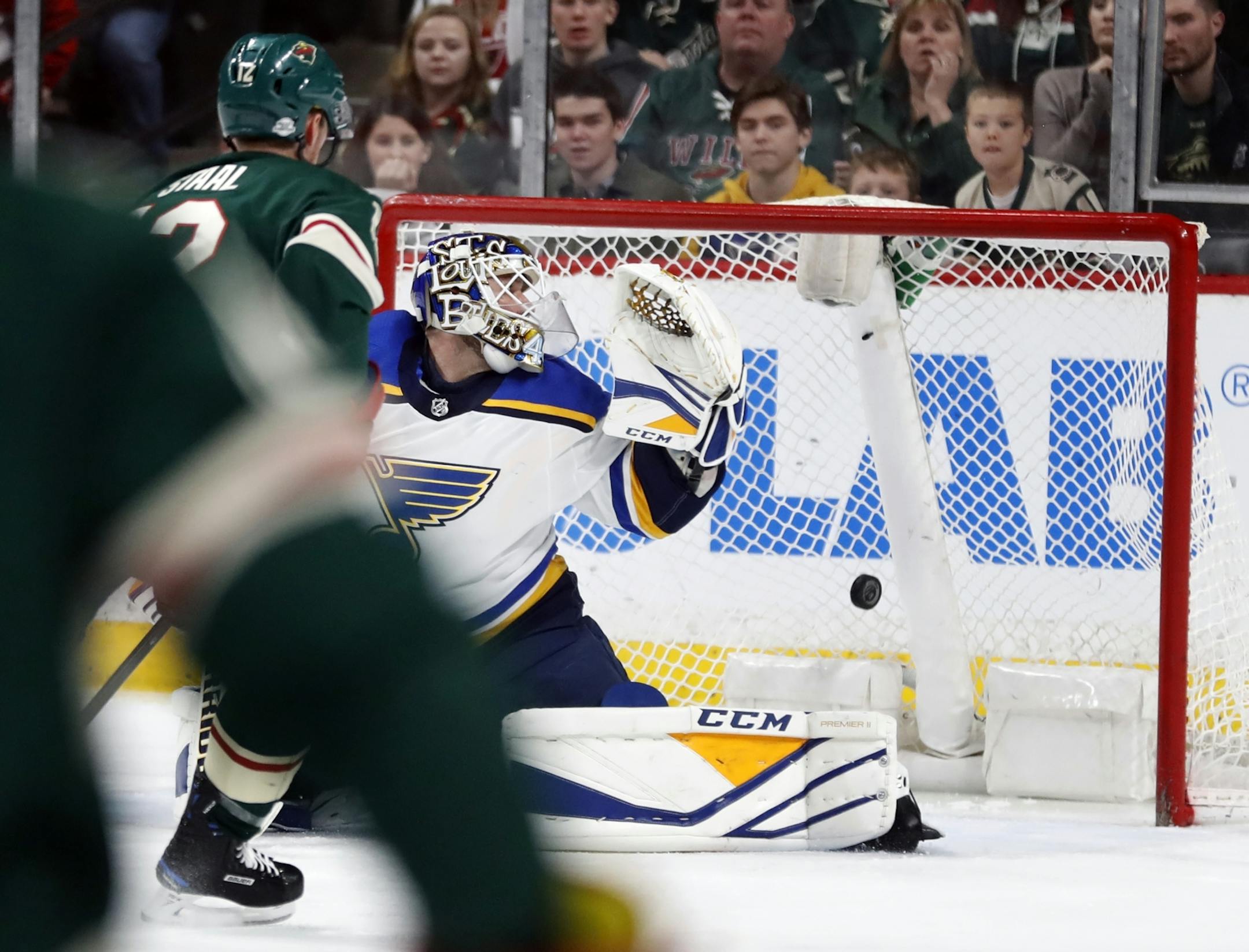 Eric Staal(12) scores the 7th goal for the Wild against Carter Huttton(40) of the Blues.