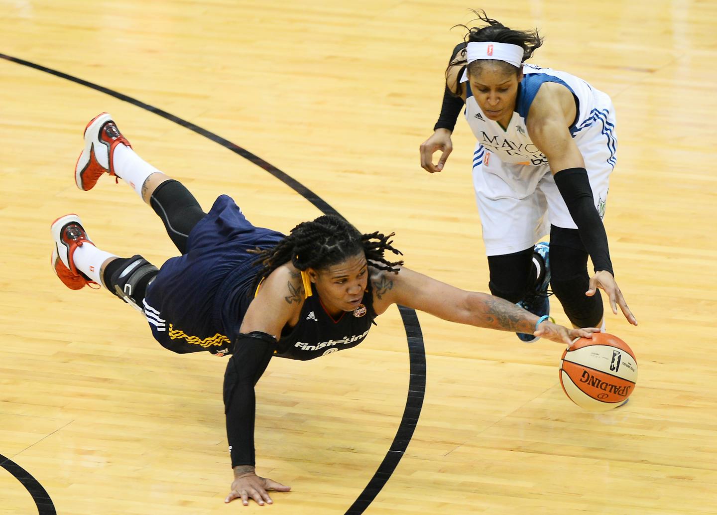 Indiana forward Erlana Larkins dove for a loose ball while being defended by Lynx forward Maya Moore in the fourth quarter of Minnesota's 77-71 victory in Game 2 of the WNBA Finals on Tuesday.