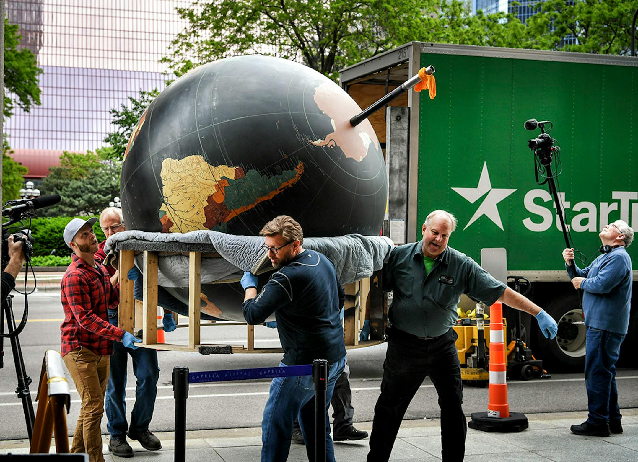 Workers from Blue Rhino Studio in Eagan handled the restoration and placement of the Star Tribune globe.