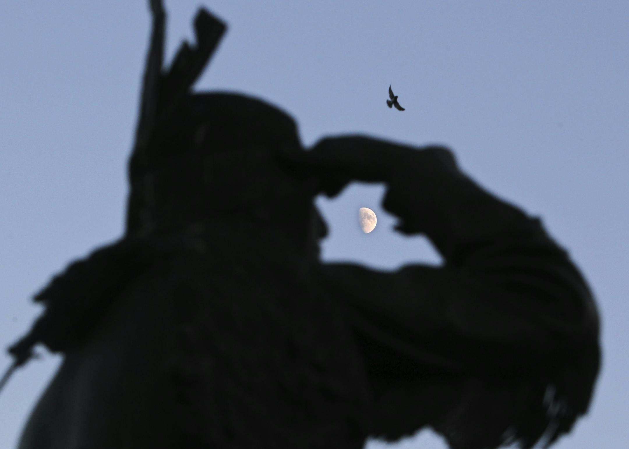 The moon and a bird in flight are seen at dusk, above a bronze sculpture of Little Crow, seen on July 27, 2012, on the banks of the Crow Creek in Hutchinson. A mere few miles to the north, LIttle Crow was felled by a bullets fired by a farmer and his son with the last name of Lamson on July 3, 1863, as Little Crow and his son picked berries in a field. On the war's 75th anniversary in 1937, hometown artist Les Kouba donated the piece, accompanied by a plaque that said: "The red of the sunset upo