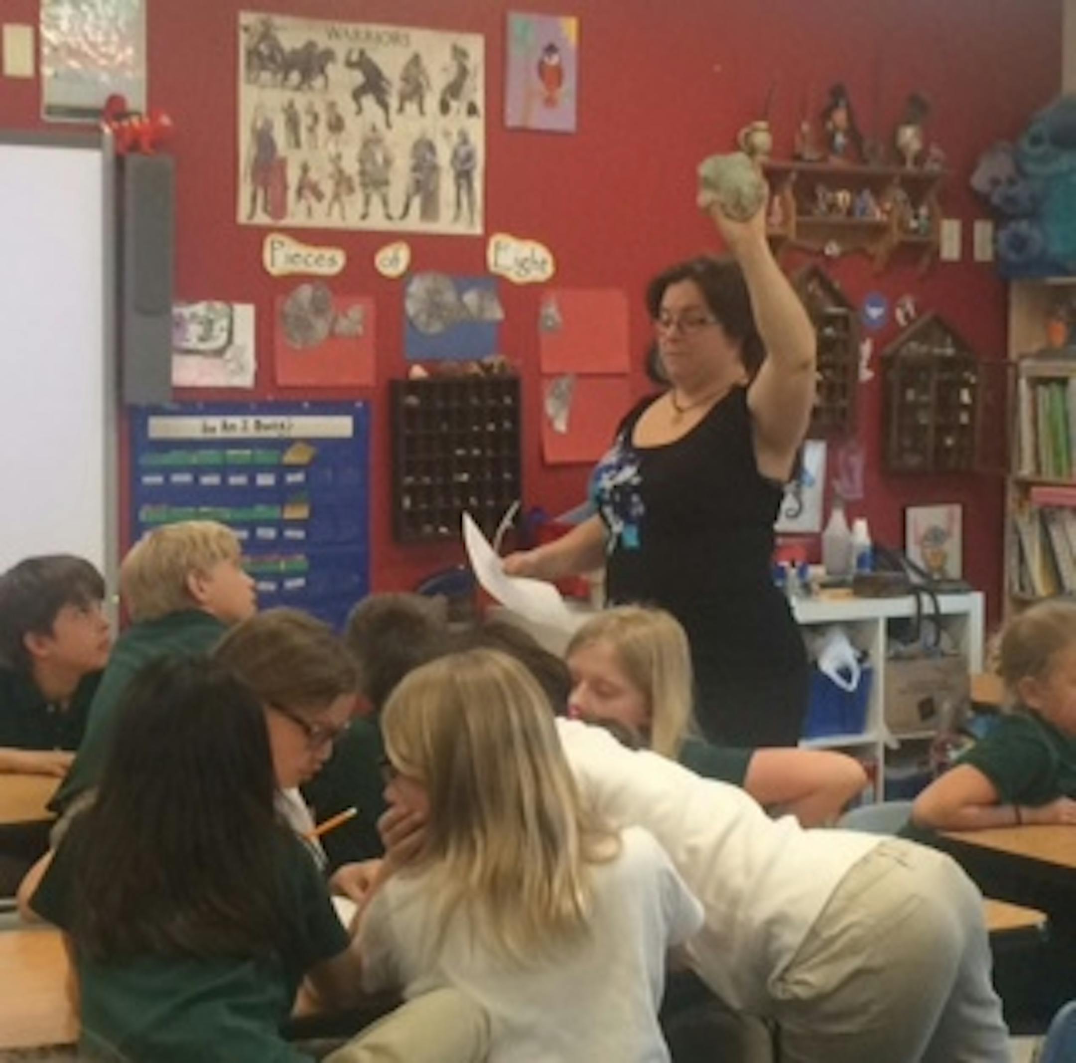 Ms. Cauley, founder of the Rockhounds Club, describes a mystery rock to students. Photo by Erin Adler.