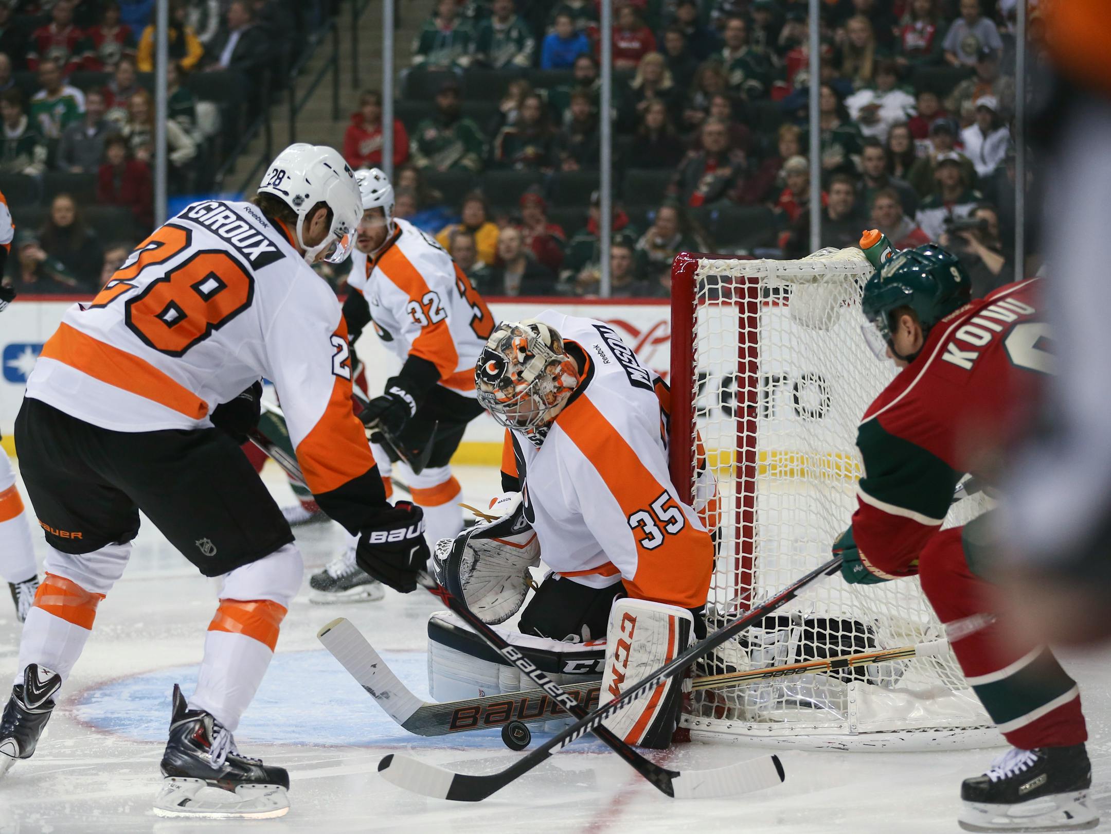 Wild center Mikko Koivu (9) reached for a puck after Philadelphia Flyers goalie Steve Mason (35) made an initial stop Thursday night in St. Paul.