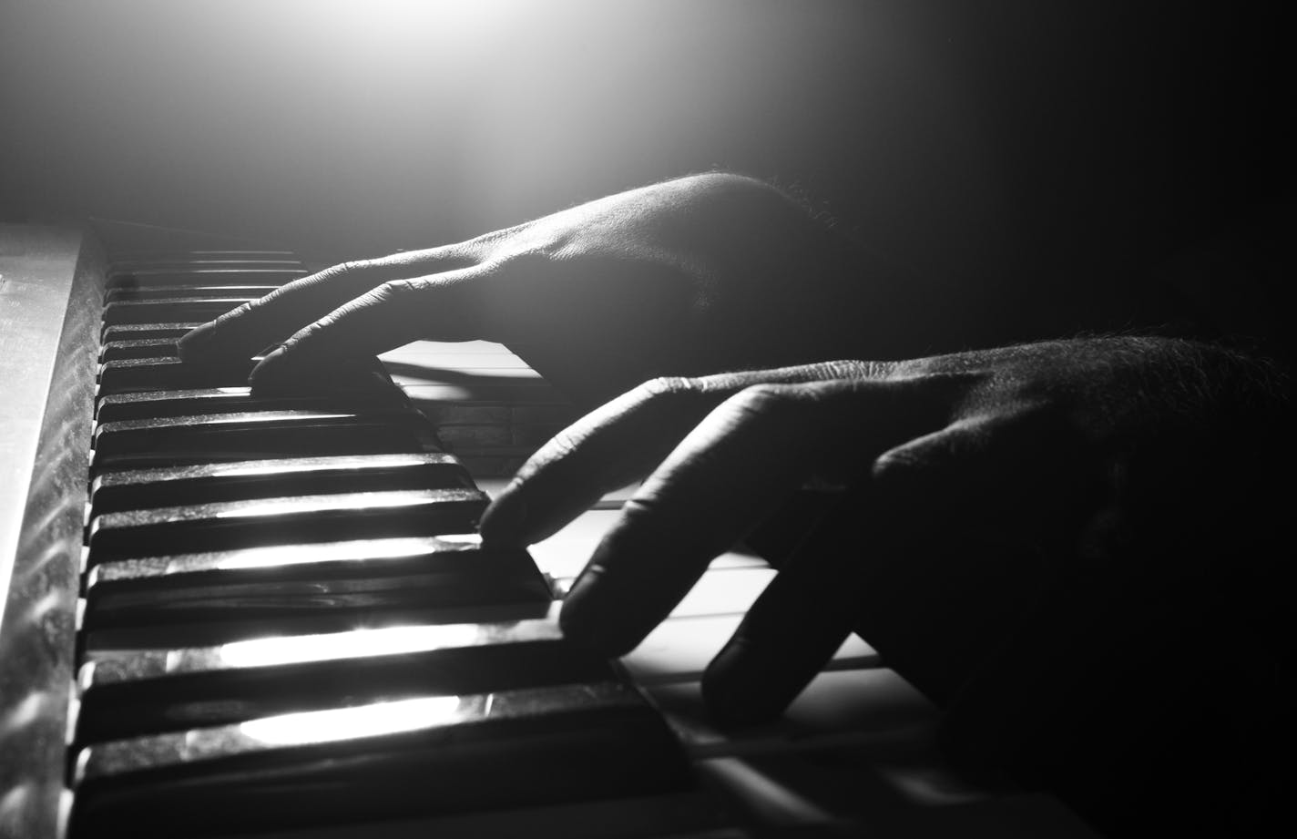 Hands playing piano close-up