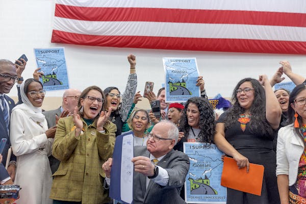 Supporters, politicians and bill authors cheered after Minnesota Gov. Tim Walz signed the driver’s licenses for all bill Tuesday at the Cedar Street