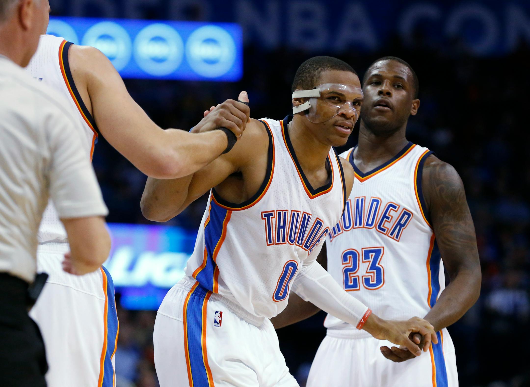 Oklahoma City Thunder guard Russell Westbrook (0) is helped up by teammates Mitch McGary, left, and Dion Waiters (23) during the third quarter of an NBA basketball game against the Minnesota Timberwolves in Oklahoma City, Friday, March 13, 2015. Oklahoma City won 113-99. (AP Photo/Sue Ogrocki)