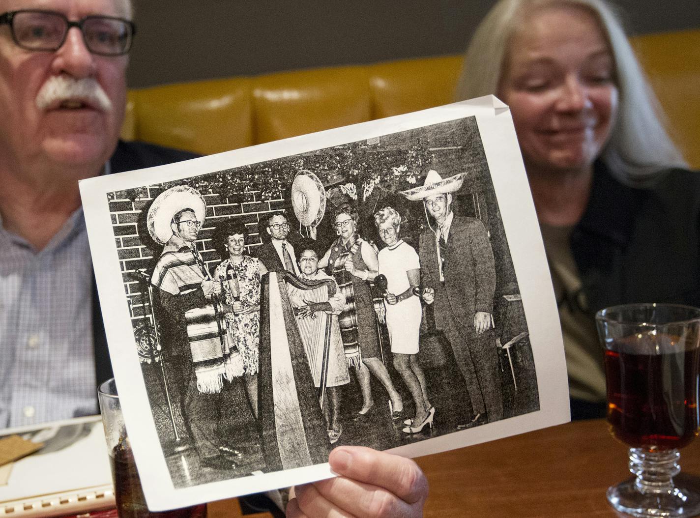 Sue Crolick smiles as Fred Webber holds up an old photo of the Minneapolis Ad Club at Casa Coronado. Second from right in the photo was president Diana Davidson. Crolick, Webber, and other former Minneapolis advertising executives gathered to recall what it was like to work in the local ad business during the &#x201a;&#xc4;&#xfa;Mad Men&#x201a;&#xc4;&#xf9; era at Murray's restaurant in downtown Minneapolis June 7, 2013. (Courtney Perry/Special to the Star Tribune)