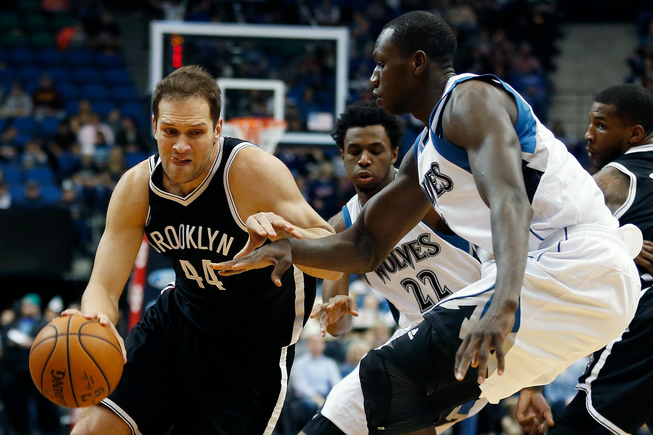 Brooklyn Nets guard Bojan Bogdanovic (44) drives the ball around Minnesota Timberwolves center Gorgui Dieng (5) in the first half of an NBA basketball game Saturday, March 5, 2016, in Minneapolis. (AP Photo/Stacy Bengs)