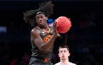Oklahoma State guard Isaac Likekele grabs a rebound during the first half of an NCAA college semi final basketball game against the Syracuse in the NI