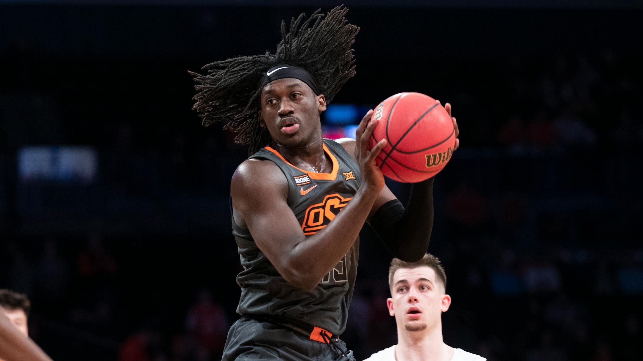 Oklahoma State guard Isaac Likekele grabs a rebound during the first half of an NCAA college semi final basketball game against the Syracuse in the NIT Season Tip-Off tournament, Wednesday, Nov. 27, 2019, in New York. (AP Photo/Mary Altaffer)
