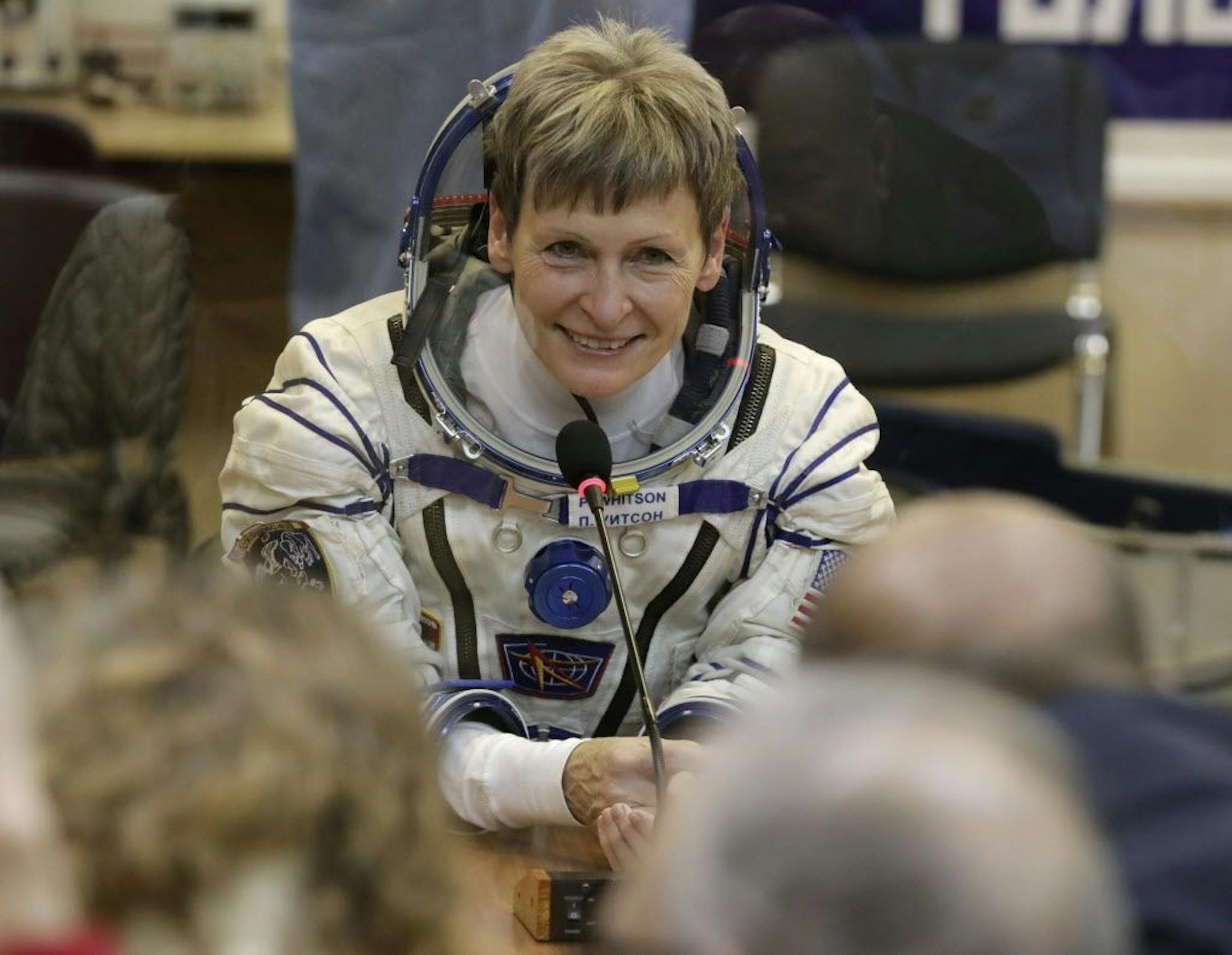 FILE - In this Nov. 17, 2016 file photo, U.S. astronaut Peggy Whitson, member of the main crew of the expedition to the International Space Station (ISS), speaks with her relatives prior the launch of Soyuz MS-3 space ship at the Russian leased Baikonur cosmodrome, Kazakhstan. On Friday, June 15, 2018, NASA announced Whitson, who has spent more time off the planet than any other American, has retired. The 58-year-old biochemist joined NASA as a researcher in 1986 and became an astronaut in 1996.