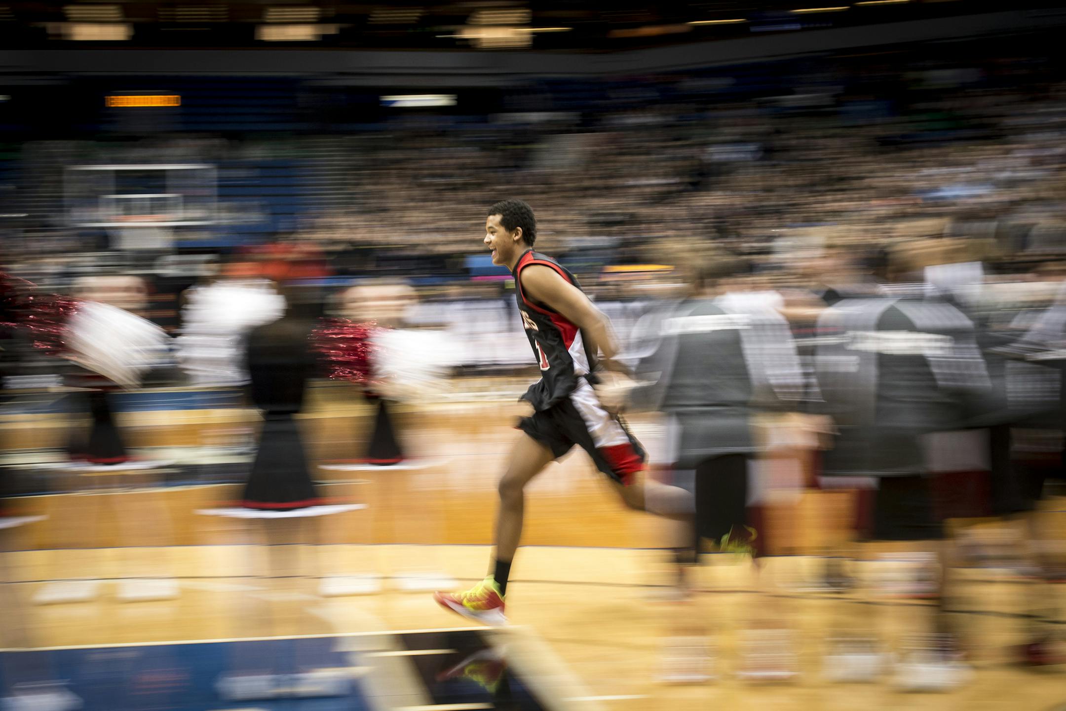 Shakopee center Steffon Mitchell (41) runs out to greet his teammates as he is introduced before Thursday night's semifinal game against Champlin Park. ] (Aaron Lavinsky | StarTribune) Shakopee plays Champlin Park in the boys' basketball Class 4A semifinals on Thursday, March 12, 2015 at Target Center