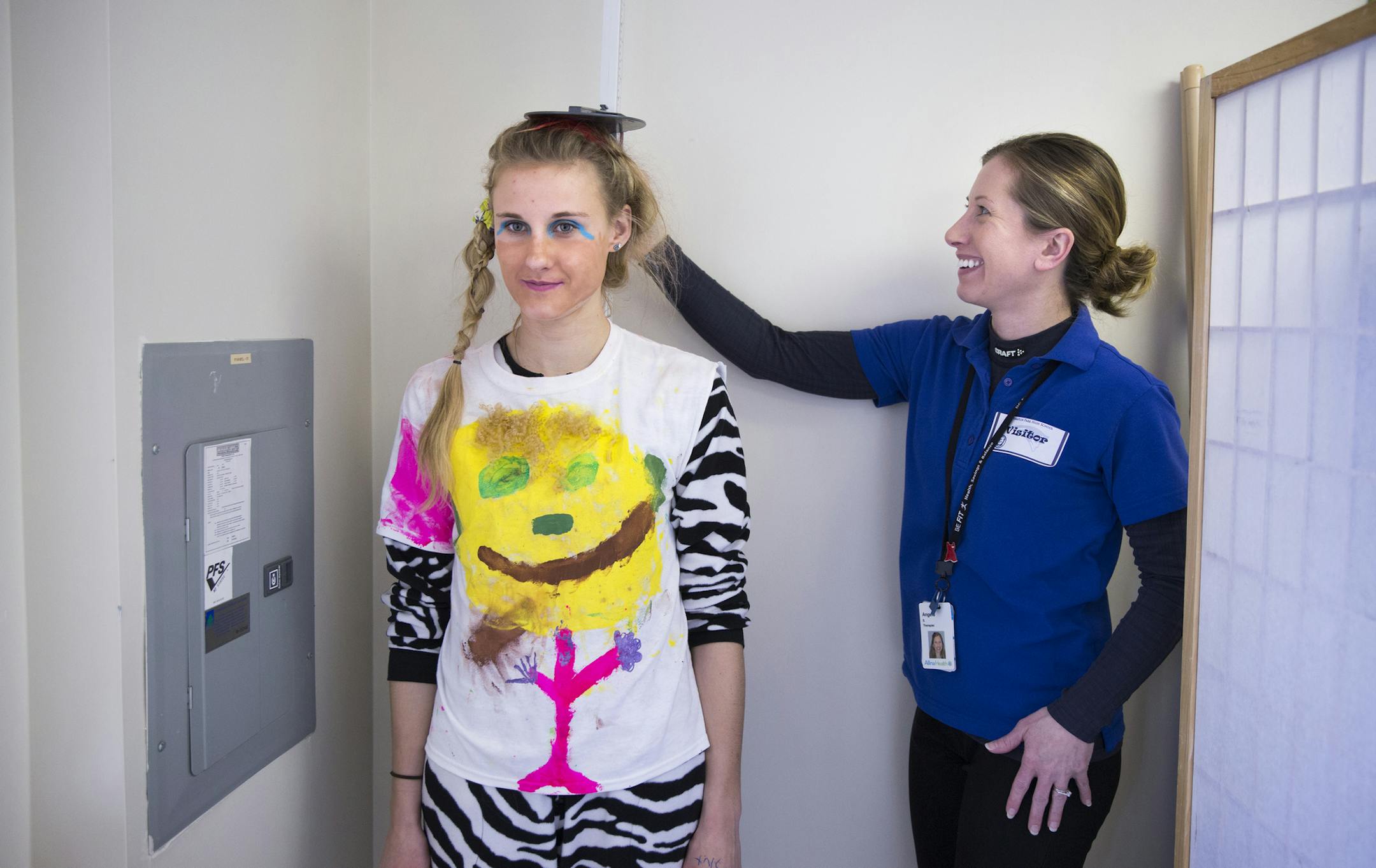 Junior Kaleigh Martinson, 16, gets her height measured for BMI by exercise physiologist Angela Stattman, right, during a health screening by Allina Health at Champlin Park High School on Tuesday, January 20, 2015. ] LEILA NAVIDI leila.navidi@startribune.com / BACKGROUND INFORMATION: An innovative teen screening program at Anoka-Hennepin schools will be adding mental health screening questions to these health screenings in an attempt to identify and address growing levels of anxiety and depressio