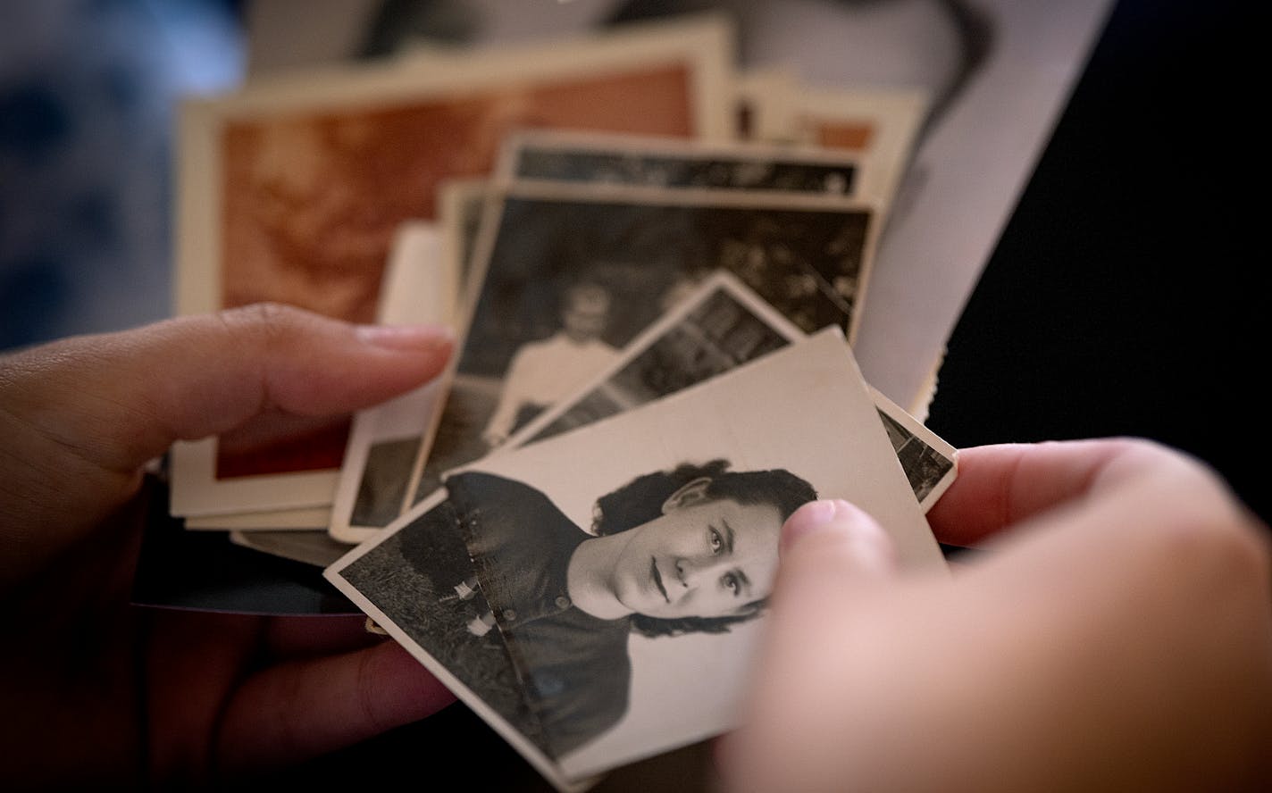 Nina Thueson and her grandmother Nina Jablonsky sift through old photos of Jablonsky at her home in Minneapolis, Minn., on Thursday, Dec. 7, 2023. ] Elizabeth Flores • liz.flores@startribune.com