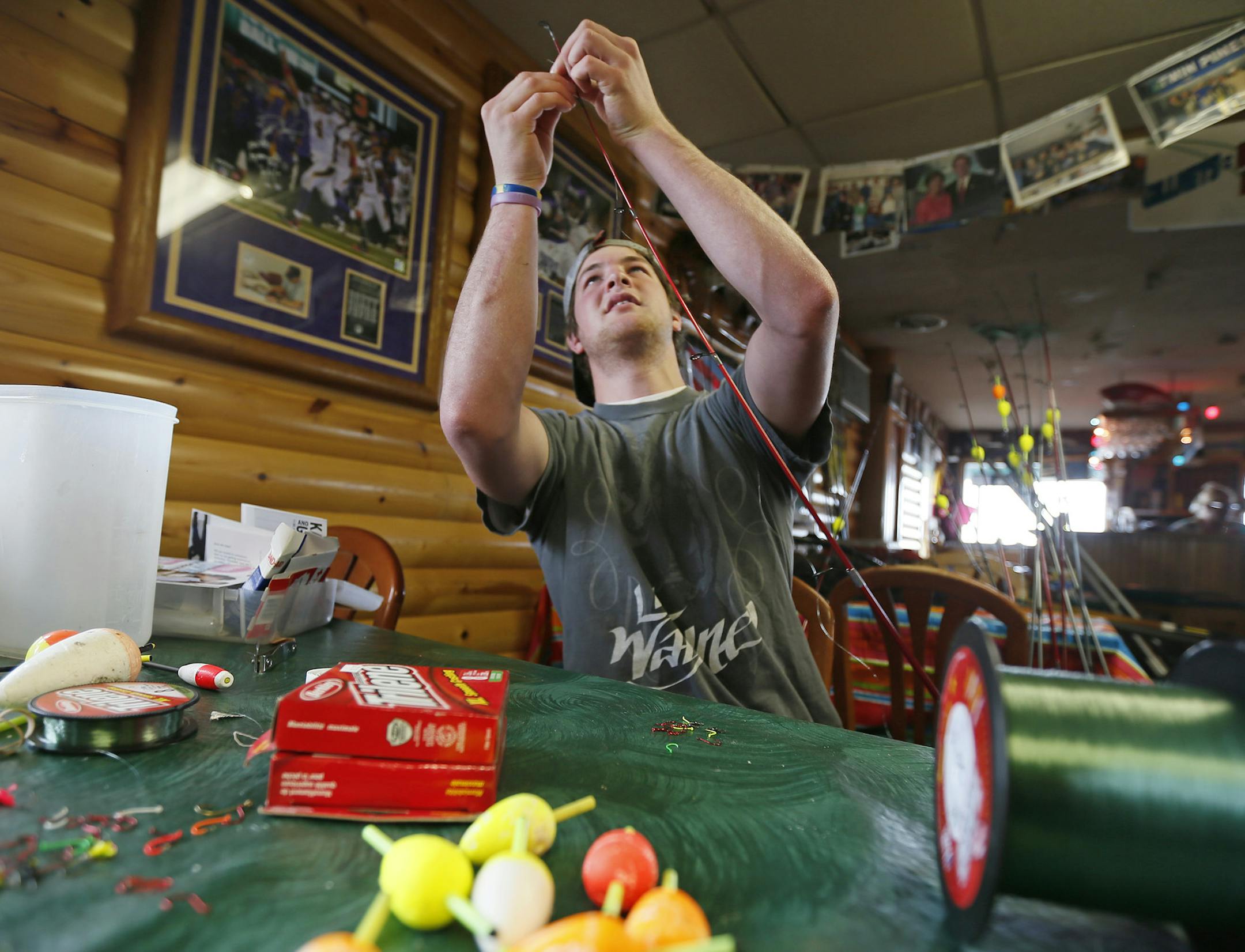 Mark Eno who's parents are owners of Twin Pines Resort tied fishing lines at their tackle shop on Thursday. Thick ice is still on Lake Millie Lacs just days before the Minnesota fishing opening as resort owner prepare for the season Thursday May 9, 2013 on the shores of Lake Millie Lacs , MN. ] JERRY HOLT ‚Ä¢ jerry.holt@startribune.com
