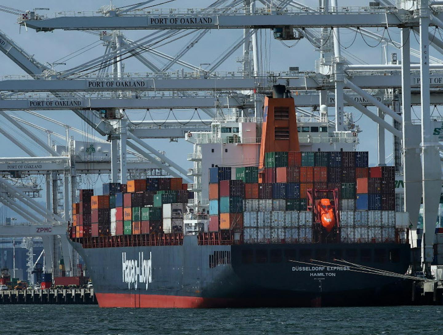 FILE- In this April 12, 2018, file photo, a container ship is unloaded at the Port of Oakland in Oakland, Calif. The International Monetary Fund has upgraded its economic outlook for the United States in 2018 and foresees a strong year for the global economy as well. The IMF predicts that the U.S. economy will grow 2.9 percent this year, up from the 2.7 percent it had forecast in January and up from the 2.3 percent growth the economy achieved last year. (AP Photo/Ben Margot, File)