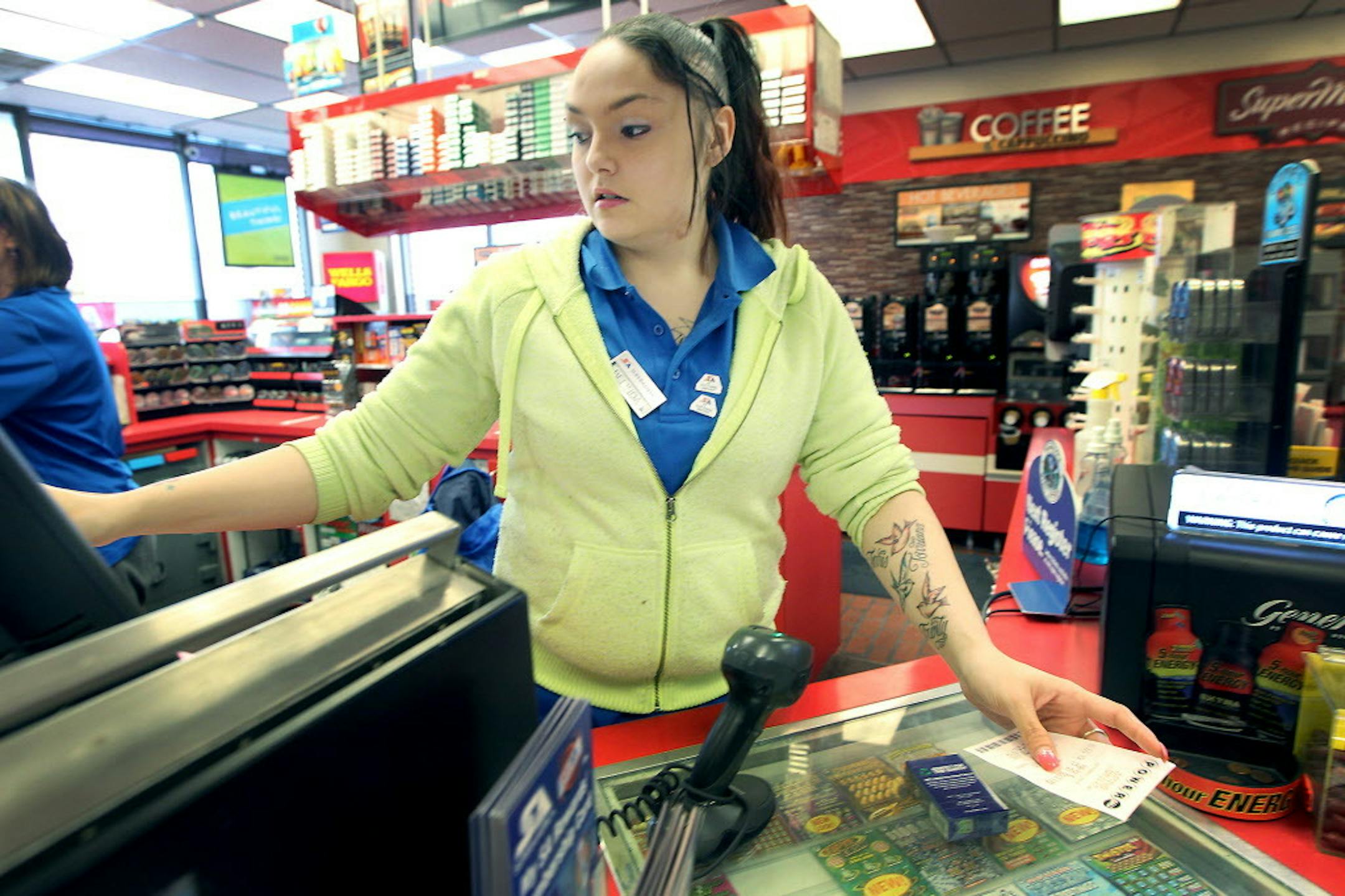 Super America cashier Belinda Contreras sold many Powerball tickets to customers on Jan. 8, 2016, in Minneapolis. The store recently sold a winning ticket for the Minnesota Millionaire.