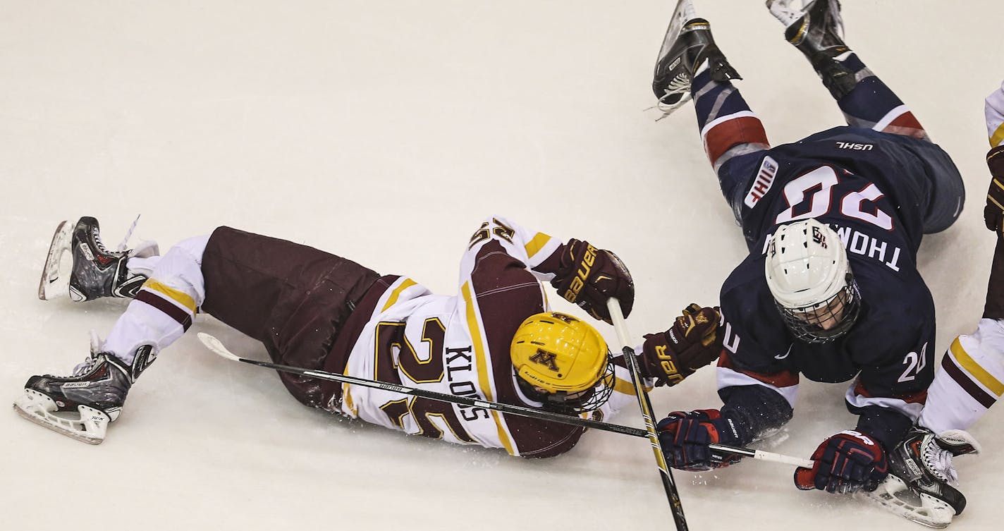 University of Minnesota Gophers Justin Kloos (25) and US U-18 team member Tage Thompson (20) go to the ice during an exhibition game Friday, Nov. 21, 2014, at Mariucci Arena on the University of Minnesota Campus in Minneapolis, MN..](DAVID JOLES/STARTRIBUNE)djoles@startribune Gophers men's hockey game, vs US U-18 team, exhibition game** Justin Kloos, Tage Thompson ,cq