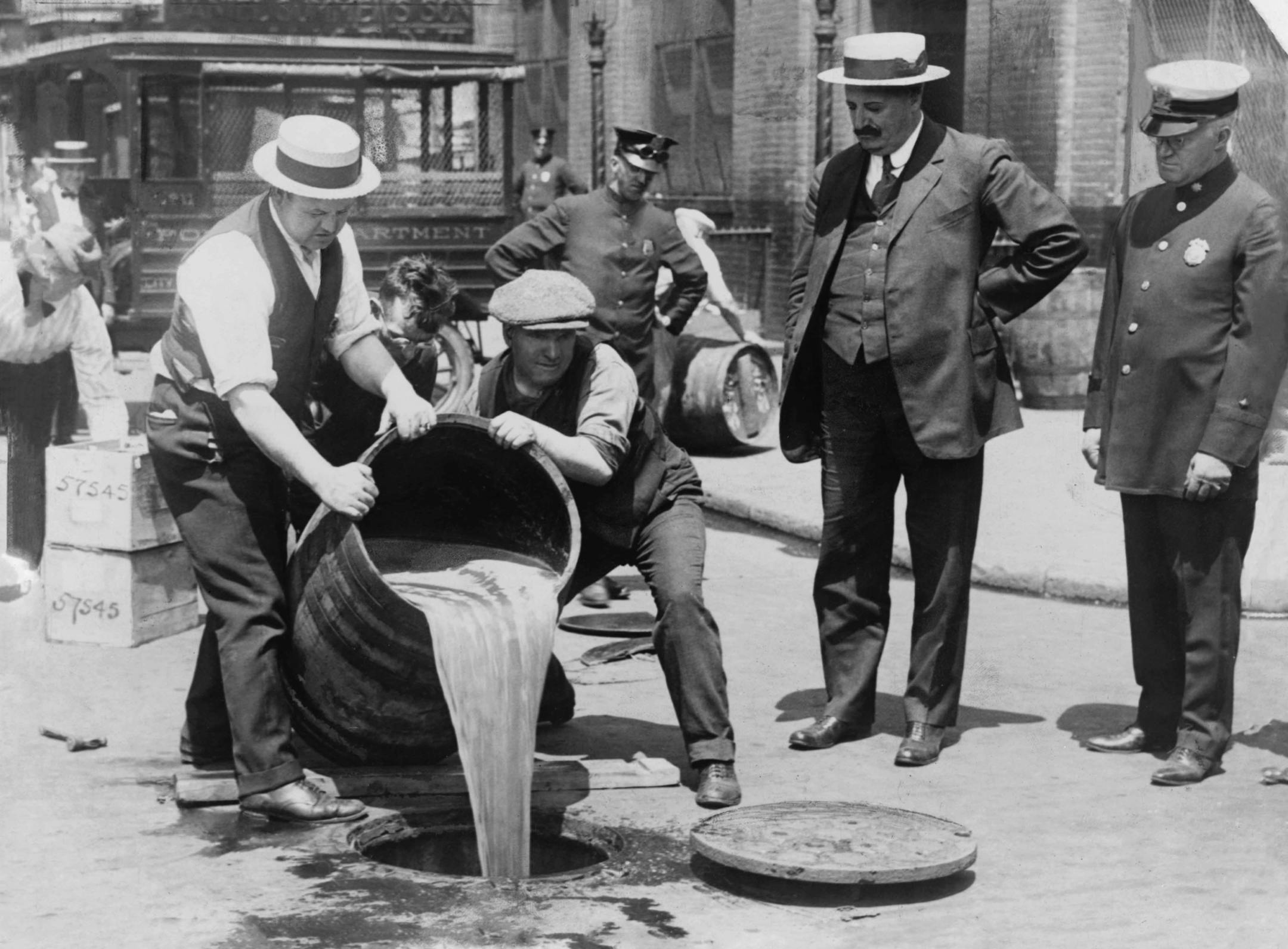 An undated handout photo of New York City police official watching agents pour liquor into a sewer following a raid during the Prohibition era, around 1921. The new PBS documentary "Prohibition" explores the roots of the 18th Amendment banning alcohol sales, wedge-issue politics and legislating morality. (Library of Congress, Prints & Photographs Division via The New York Times) -- EDITORIAL USE ONLY. -- PHOTO MOVED IN ADVANCE AND NOT FOR USE - ONLINE OR IN PRINT - BEFORE SEPT. 25, 2011.