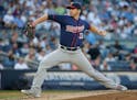 Minnesota Twins' Tommy Milone (33) winds up during the second inning of the team's baseball game against the New York Yankees on Friday, June 24, 2016