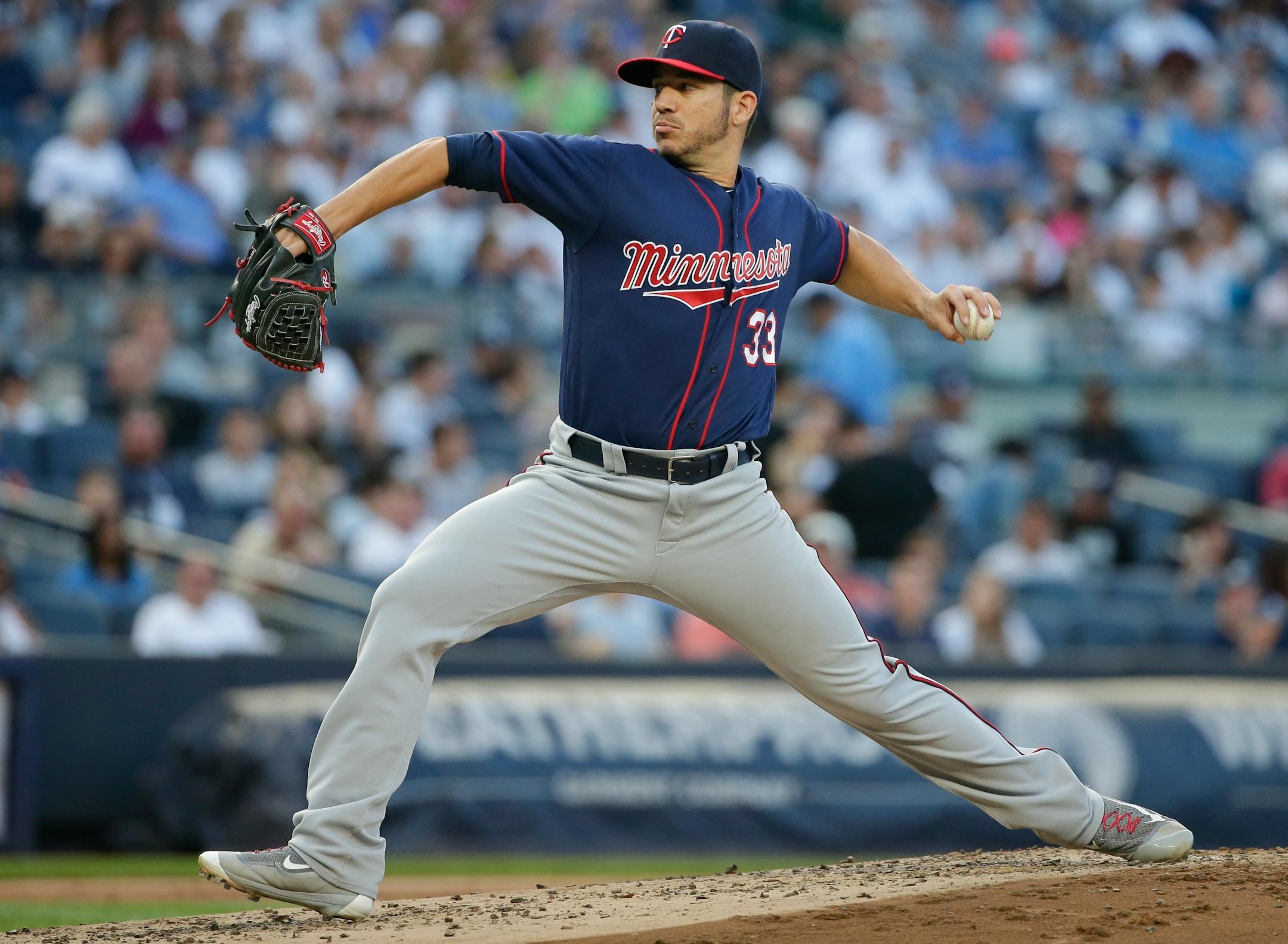 Minnesota Twins' Tommy Milone (33) winds up during the second inning of the team's baseball game against the New York Yankees on Friday, June 24, 2016, in New York.