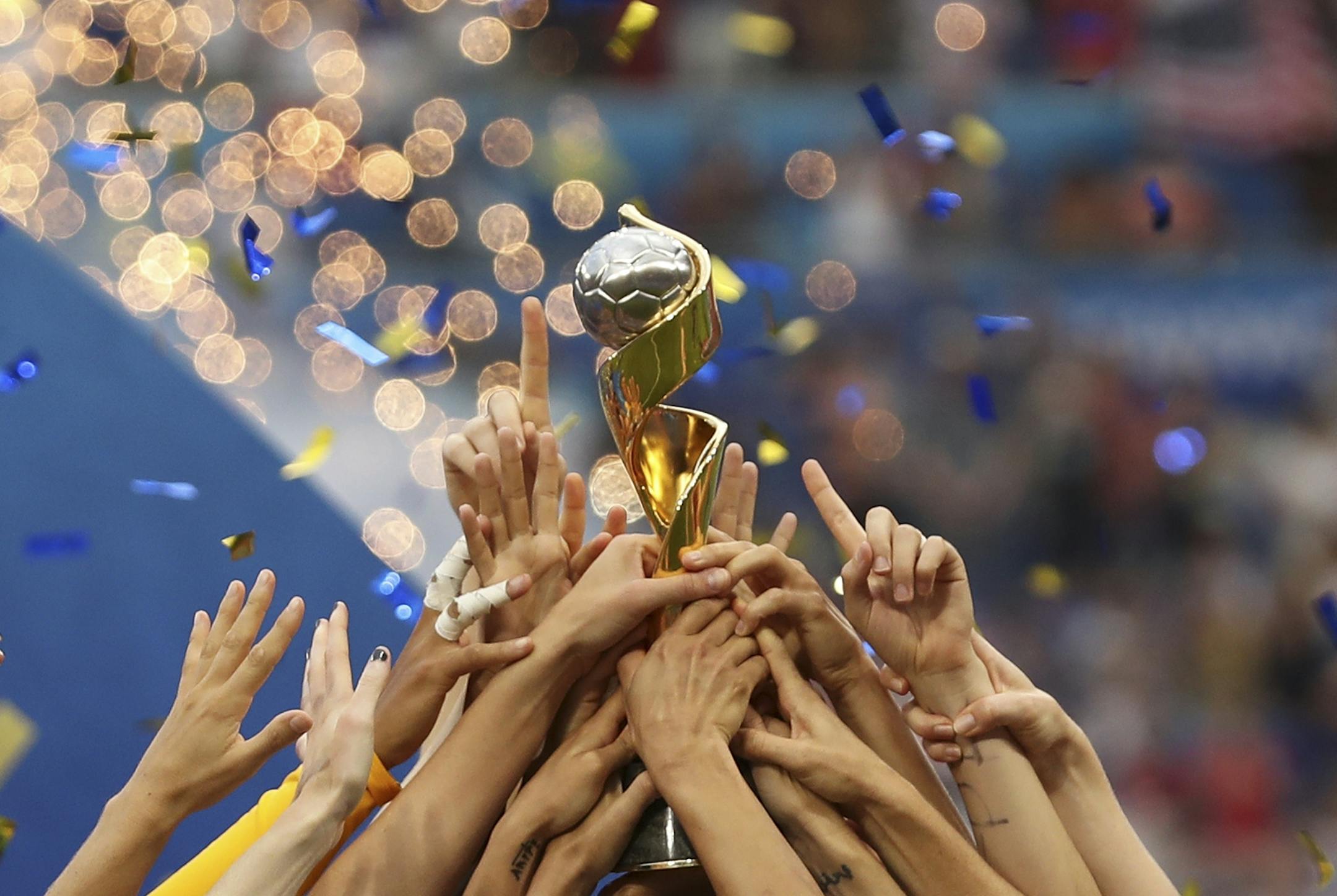 The United States players hold the trophy celebrating at the end of the Women's World Cup final soccer match between US and The Netherlands at the Stade de Lyon in Decines, outside Lyon, France, Sunday, July 7, 2019. The US defeated the Netherlands 2-0.
