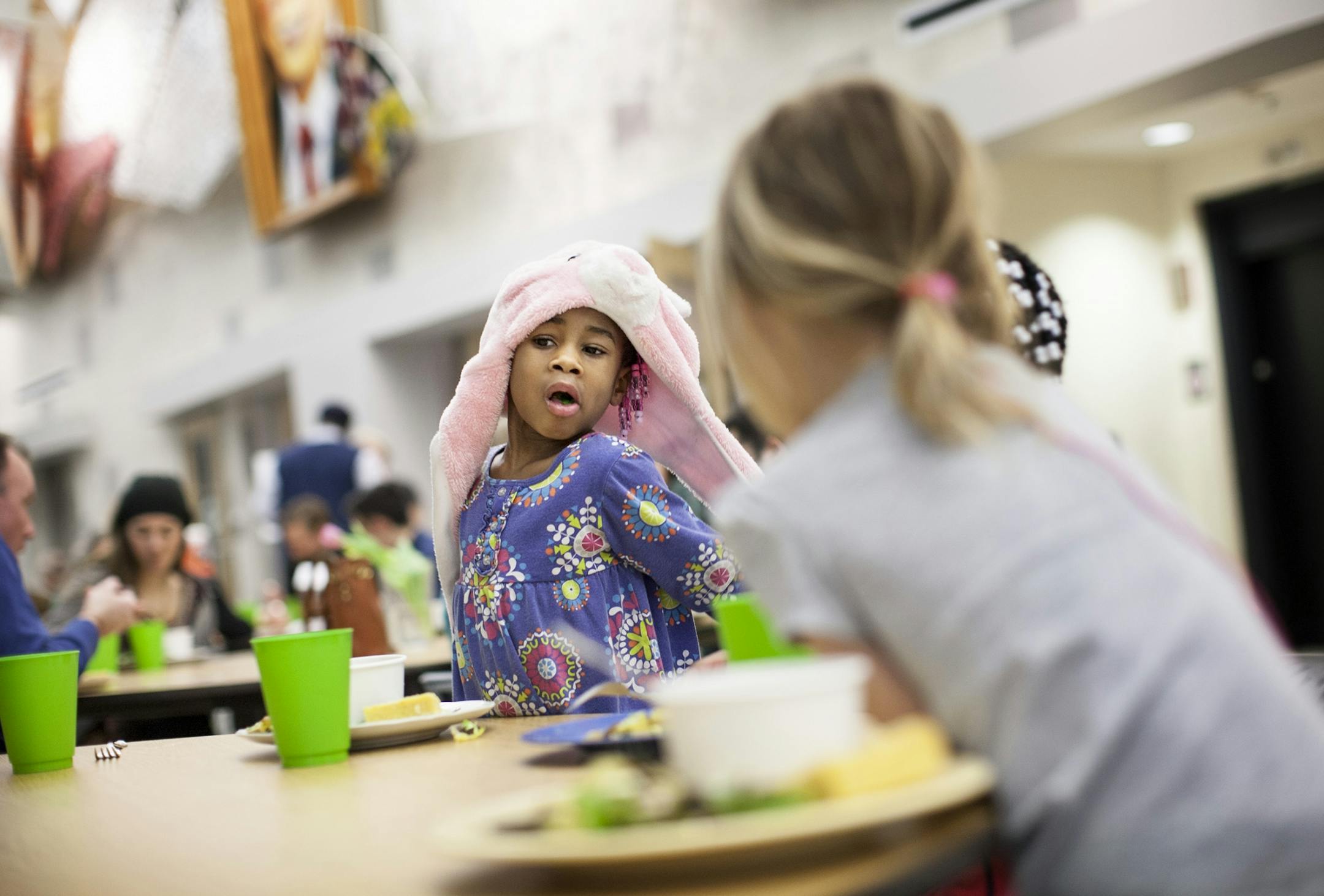 Maleli Van Pelt, 4, enjoys dinner with family and friends at Eat for Equity's community feast benefitting Urban Ventures at the Urban Ventures headquarters in Minneapolis January 31, 2015.