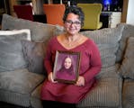 DeYanna Ostroushko with a photo of her mother, Debbie Nash Sedaghat, who died at age 24, just two weeks after DeYanna’s first birthday.