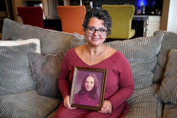 DeYanna Ostroushko with a photo of her mother, Debbie Nash Sedaghat, who died at age 24, just two weeks after DeYanna’s first birthday.