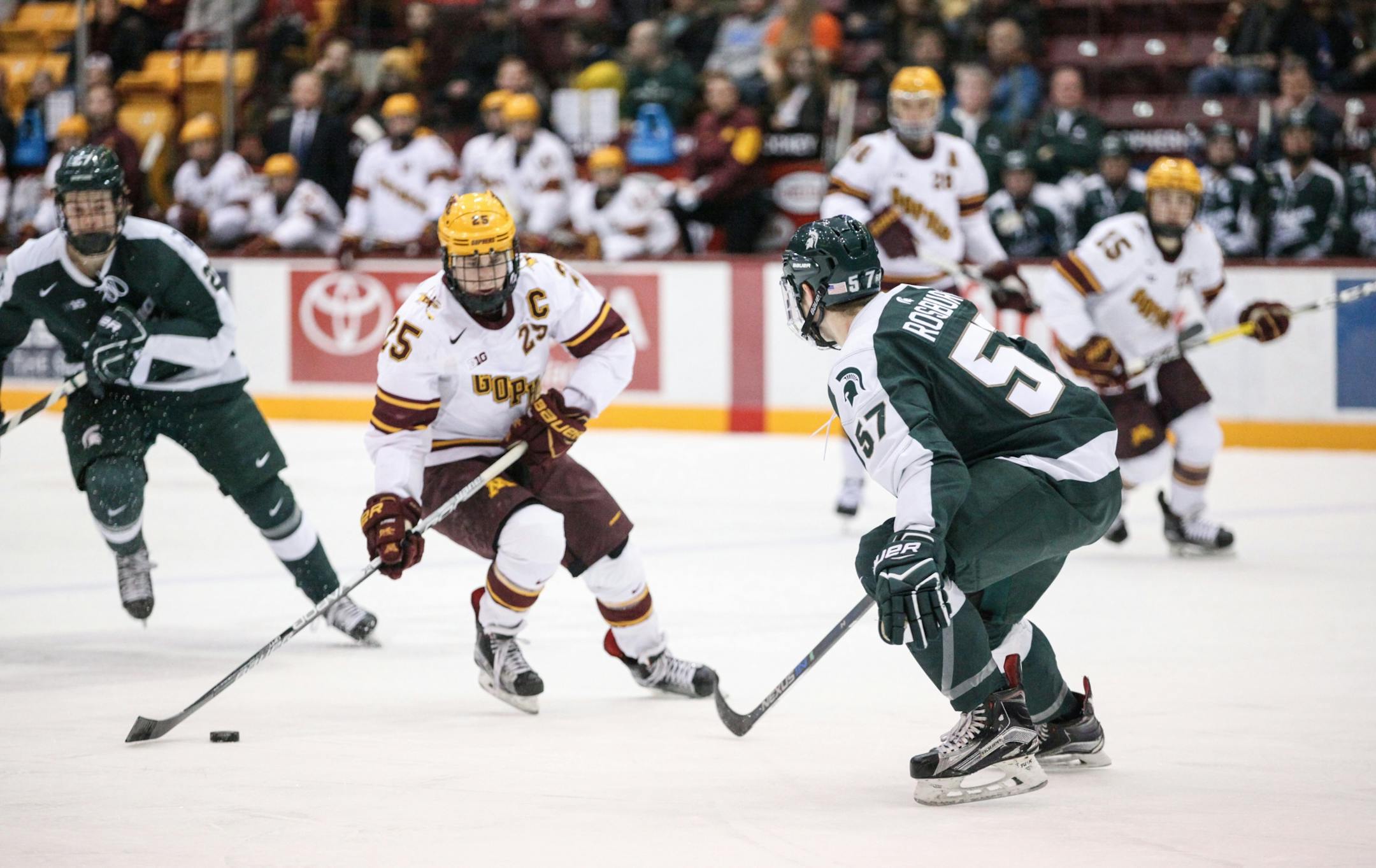 Michigan State Spartans� Jerad Rosburg (57) tries to block Minnesota Gophers� Justin Kloos (25)'s shot in the first period.